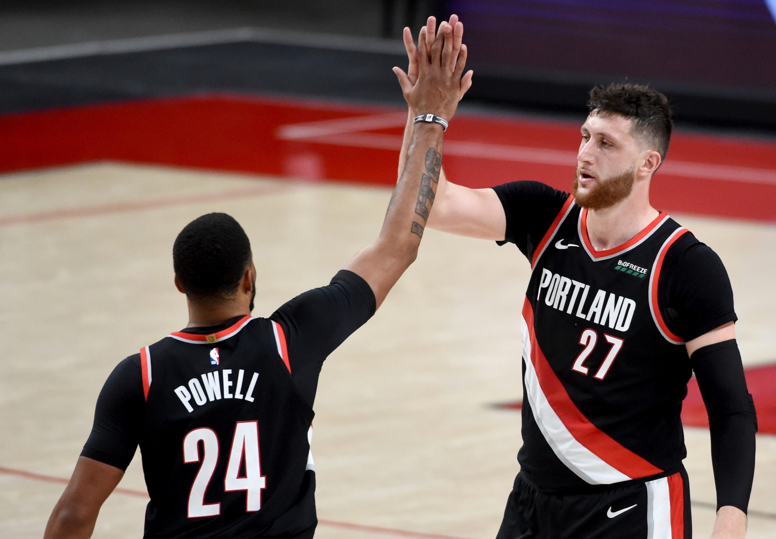 Portland Trail Blazers forward Norman Powell, left, celebrates with center Jusuf Nurkic, right, during the second half of Game 4 of an NBA basketball first-round playoff series against the Denver Nuggets in Portland, Ore., Saturday, May 29, 2021. The Blazers won 1115-95. (AP Photo/Steve Dykes)