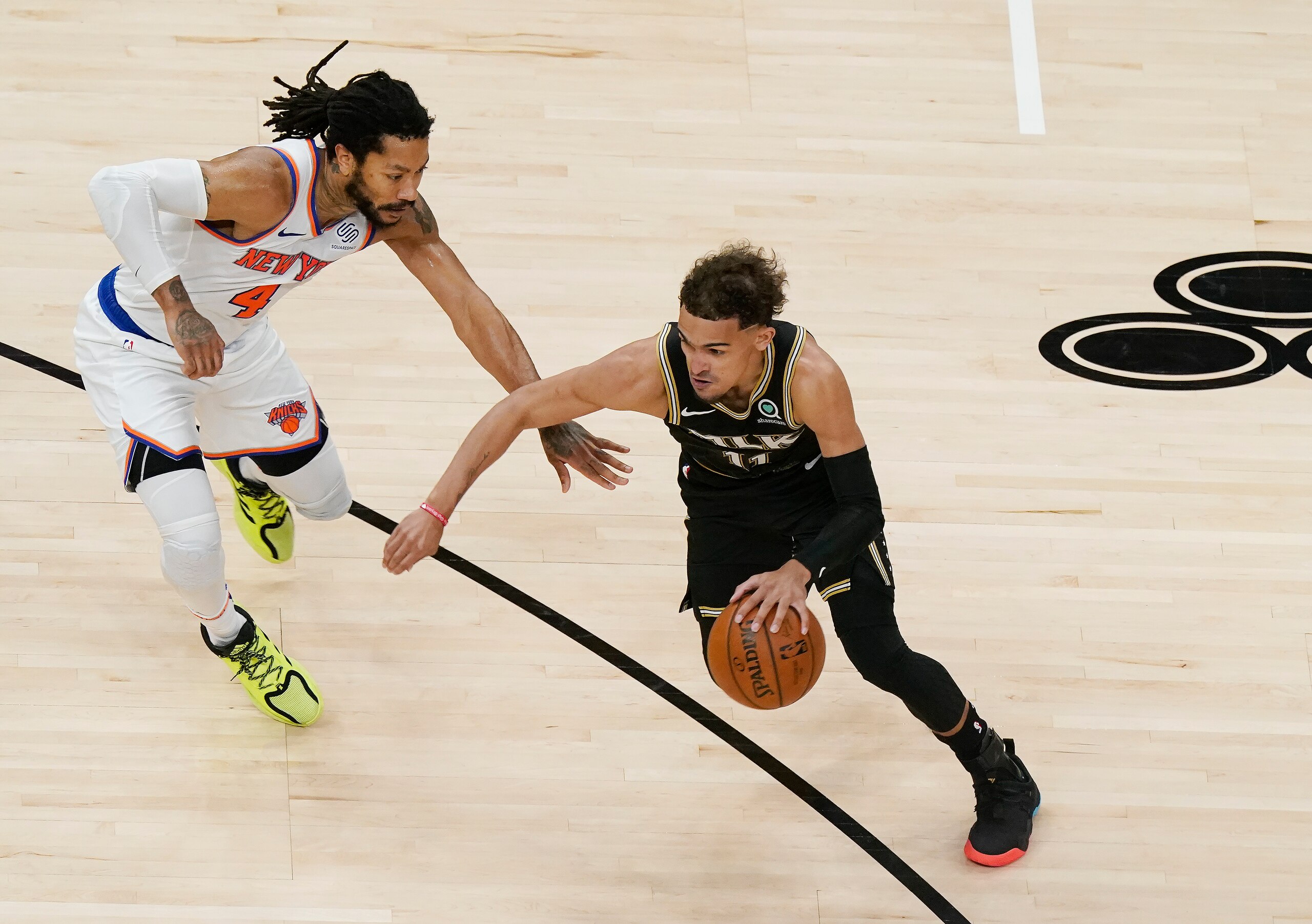 Atlanta Hawks guard Trae Young (11) dribbles the ball against New York Knicks guard Derrick Rose (4) during the first half in Game 4 of an NBA basketball first-round playoff series Sunday, May 30, 2021, in Atlanta. (AP Photo/Brynn Anderson)