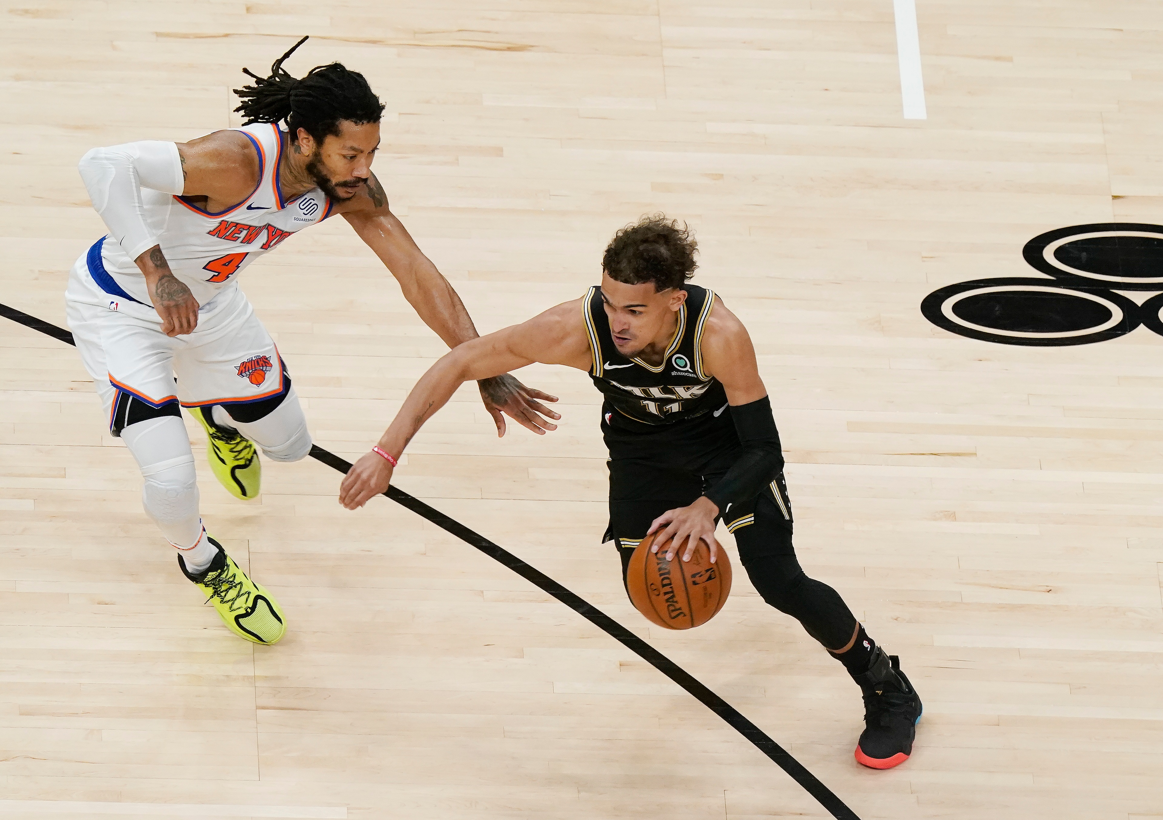 Atlanta Hawks guard Trae Young (11) dribbles the ball against New York Knicks guard Derrick Rose (4) during the first half in Game 4 of an NBA basketball first-round playoff series Sunday, May 30, 2021, in Atlanta. (AP Photo/Brynn Anderson)