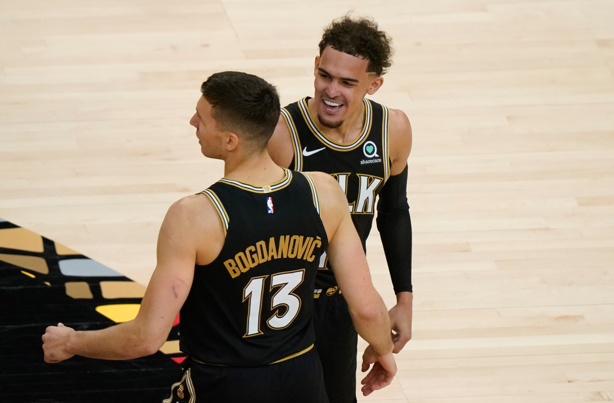 Atlanta Hawks guard Trae Young (11) congratulates Bogdan Bogdanovic (13) after Bogdanovic scores during the first half in Game 4 of an NBA basketball first-round playoff series Sunday, May 30, 2021, in Atlanta. (AP Photo/Brynn Anderson)