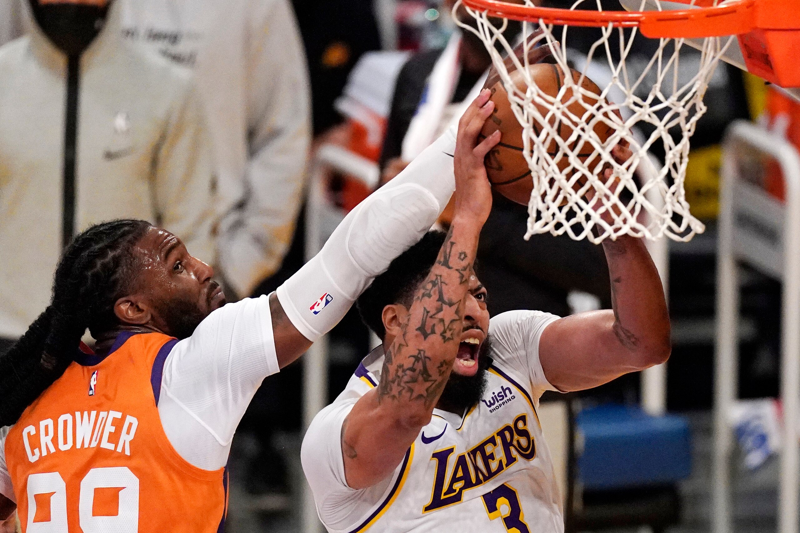 Los Angeles Lakers forward Anthony Davis, right, shoots as Phoenix Suns forward Jae Crowder defends during the first half in Game 4 of an NBA basketball first-round playoff series Sunday, May 30, 2021, in Los Angeles. (AP Photo/Mark J. Terrill)
