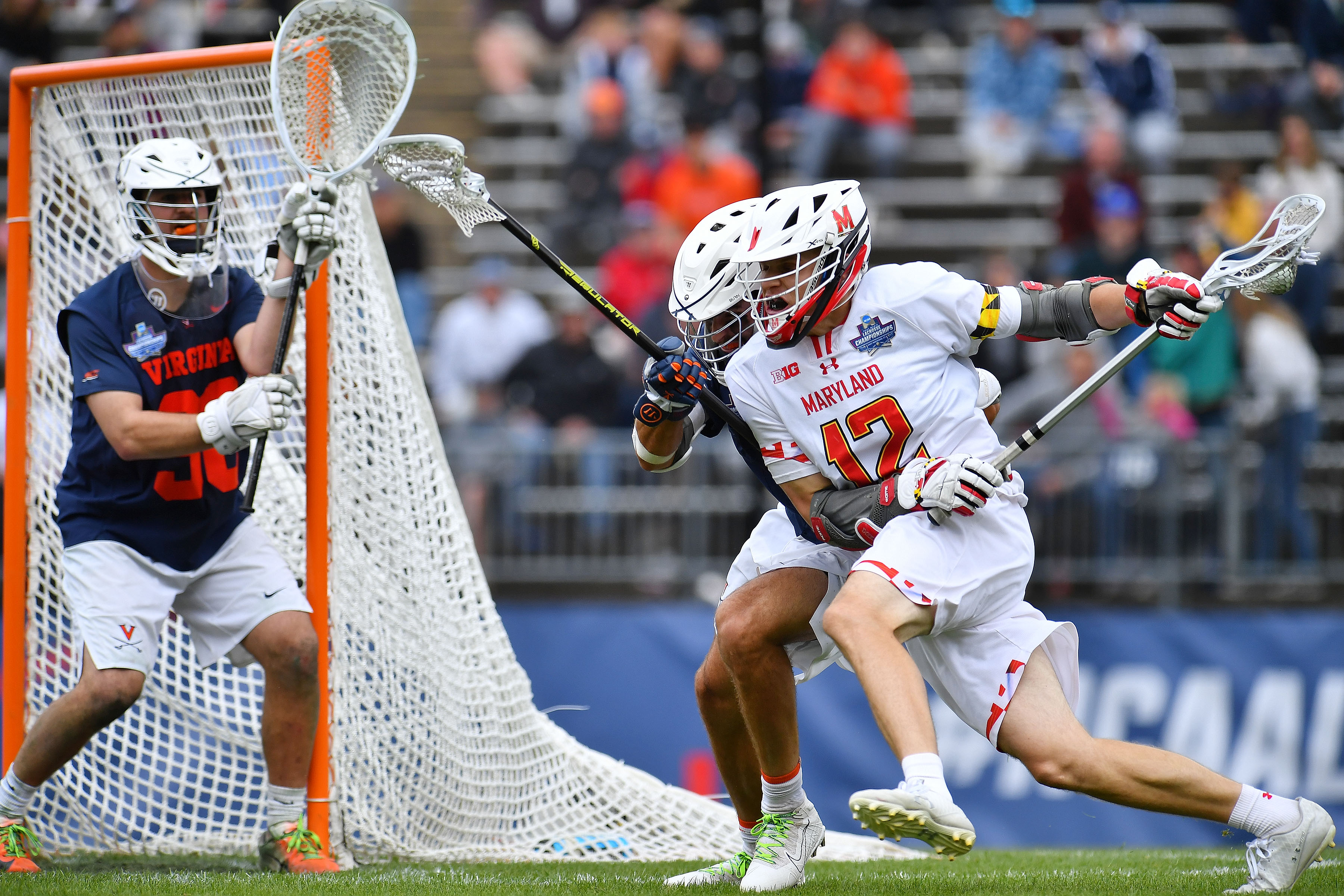 EAST HARTFORD, CT - MAY 31: Maryland Terrapins attacker Logan Wisnauskas (12) runs against Virginia Cavaliers defender Jared Connors (28) as goalie Alex Rode (38) waits during the Division I Mens Lacrosse Championship held at Pratt and Whitney Stadium at Rentschler Field on May 31, 2021 in East Hartford, Connecticut. (Photo by Larry French/NCAA Photos via Getty Images)