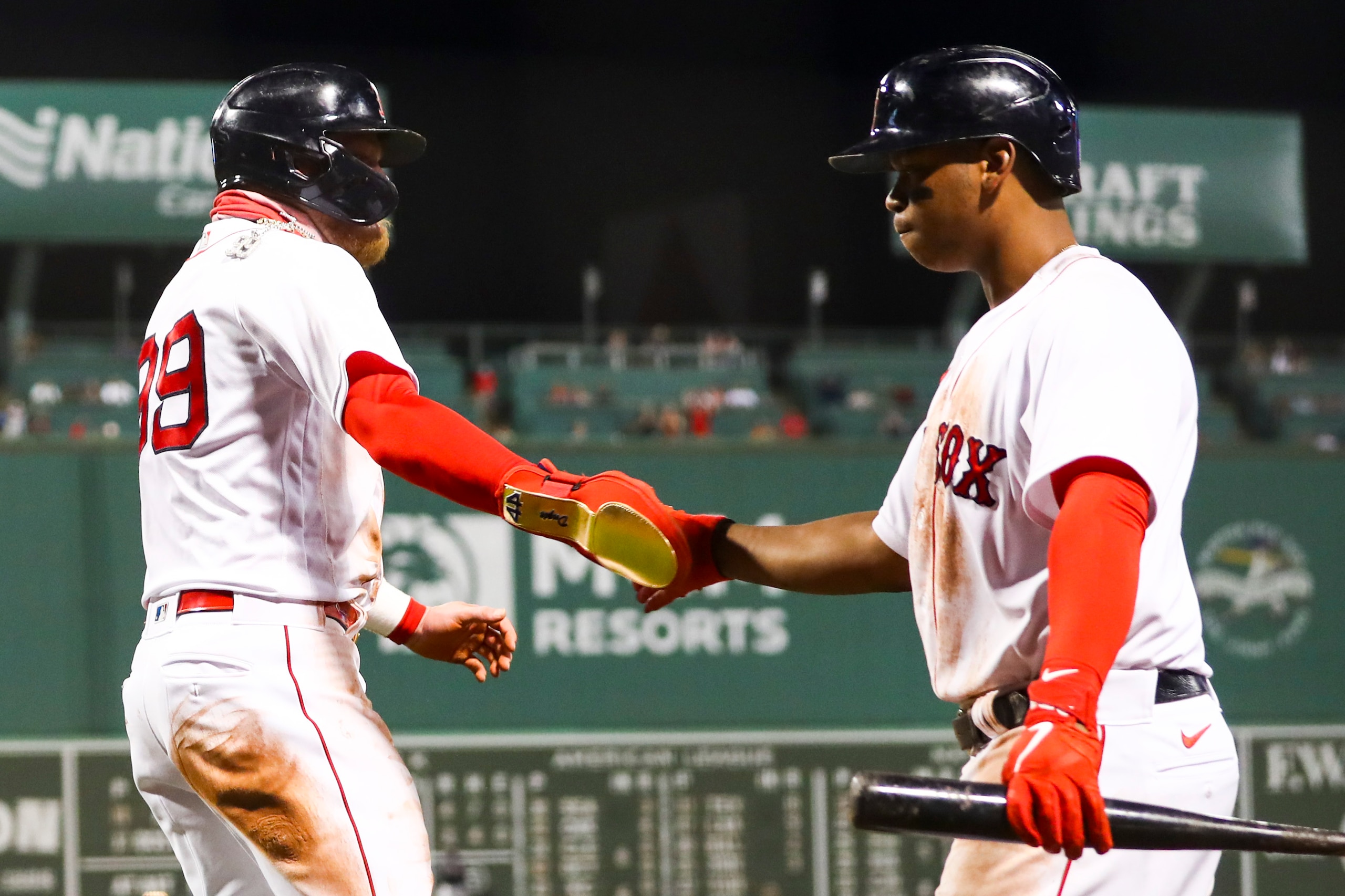 BOSTON, MA - MAY 26: Alex Verdugo #99 of the Boston Red Sox high fives Rafael Devers #11 of the Boston Red Sox after scoring in the sixth inning of a game against the Atlanta Braves at Fenway Park on May 26, 2021 in Boston, Massachusetts.  (Photo by Adam Glanzman/Getty Images)
