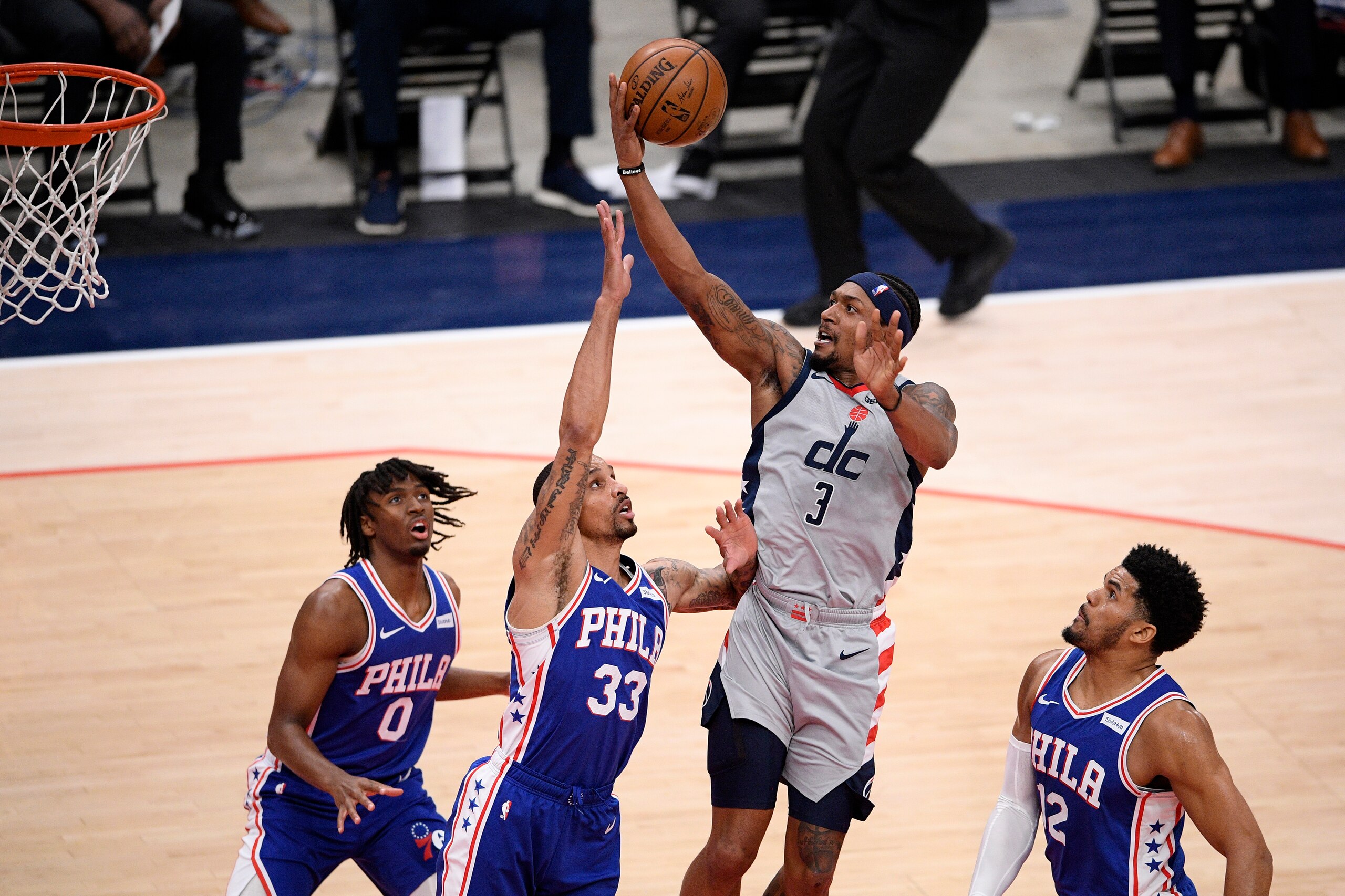 Washington Wizards guard Bradley Beal (3) goes to the basket against Philadelphia 76ers guard George Hill (33), forward Tobias Harris (12) and guard Tyrese Maxey (0) during the first half of Game 4 in a first-round NBA basketball playoff series, Monday, May 31, 2021, in Washington. (AP Photo/Nick Wass)