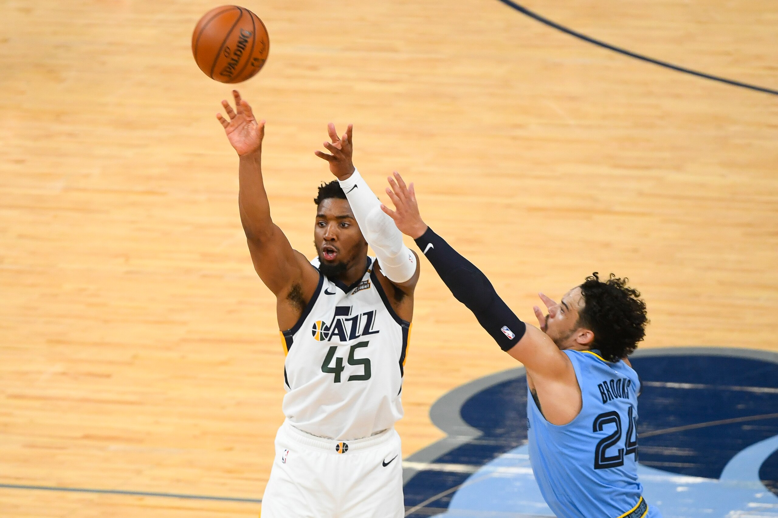 Utah Jazz guard Donovan Mitchell (45) shoots as Memphis Grizzlies forward Dillon Brooks (24) defends during the second half of Game 3 of an NBA basketball first-round playoff series Saturday, May 29, 2021, in Memphis, Tenn. Utah won 121-111. (AP Photo/John Amis)