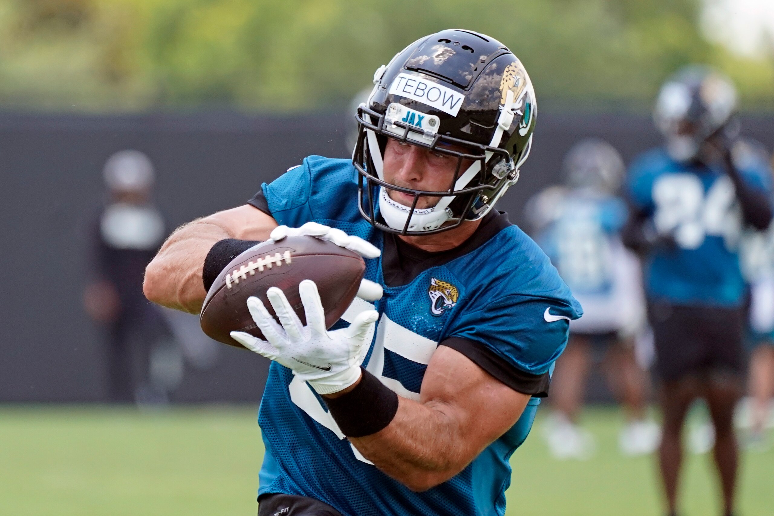 Jacksonville Jaguars tight end Tim Tebow catches a pass during NFL football practice, Thursday, May 27, 2021, in Jacksonville, Fla. (AP Photo/John Raoux)