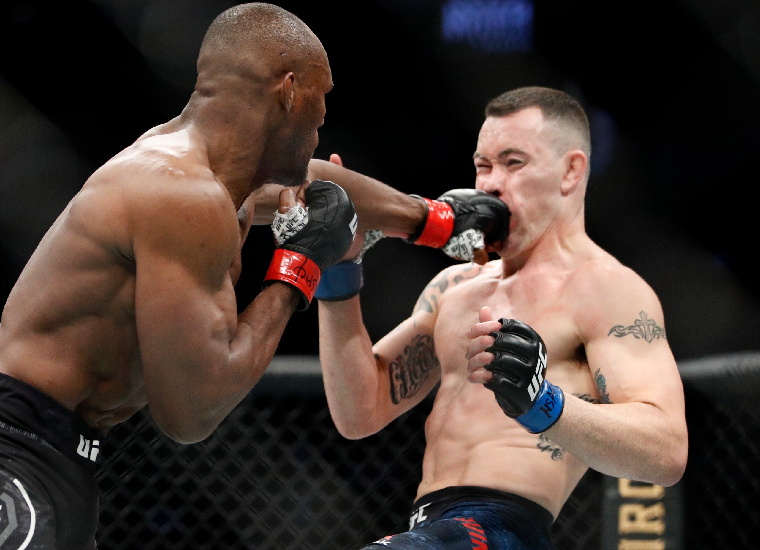 Kamaru Usman hits Colby Covington in a mixed martial arts welterweight championship bout at UFC 245, Saturday, Dec. 14, 2019, in Las Vegas. (AP Photo/John Locher) Kamaru Usman hits Colby Covington in a mixed martial arts welterweight championship bout at UFC 245, Saturday, Dec. 14, 2019, in Las Vegas. (AP Photo/John Locher)