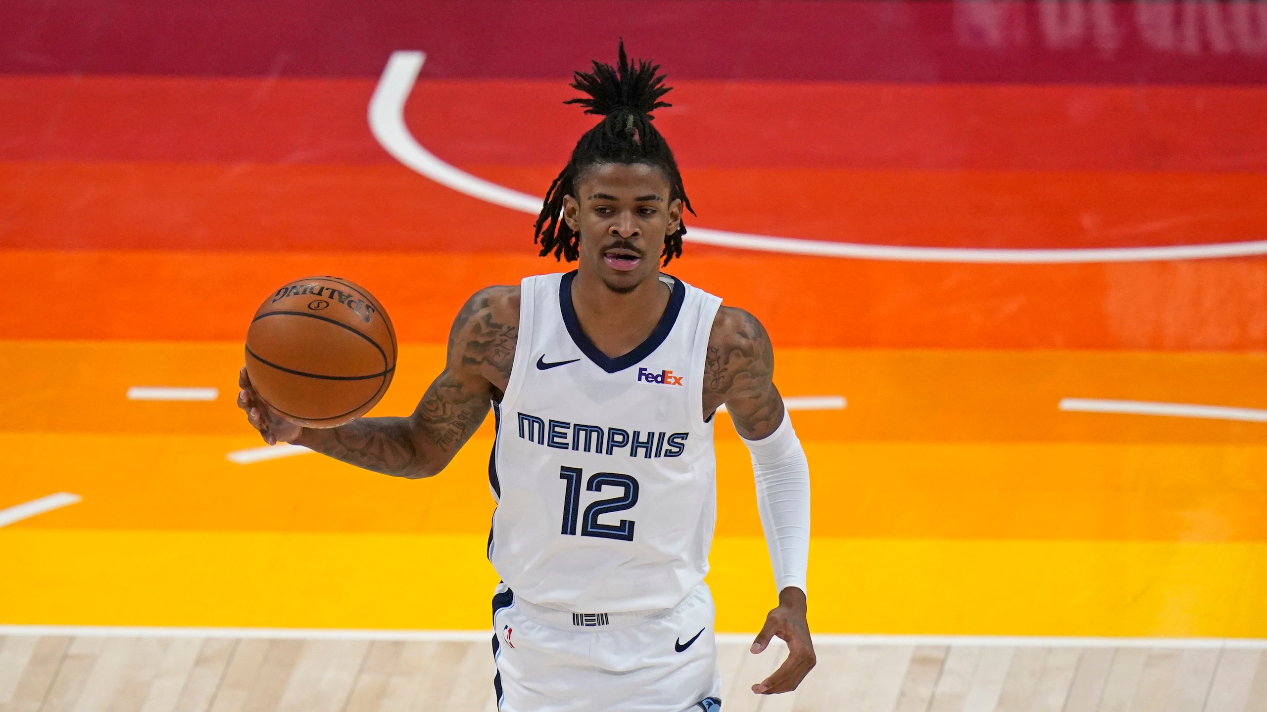 Memphis Grizzlies guard Ja Morant (12) brings the ball up court during the first half of Game 2 of their NBA basketball first-round playoff series against the Utah Jazz Wednesday, May 26, 2021, in Salt Lake City. (AP Photo/Rick Bowmer)