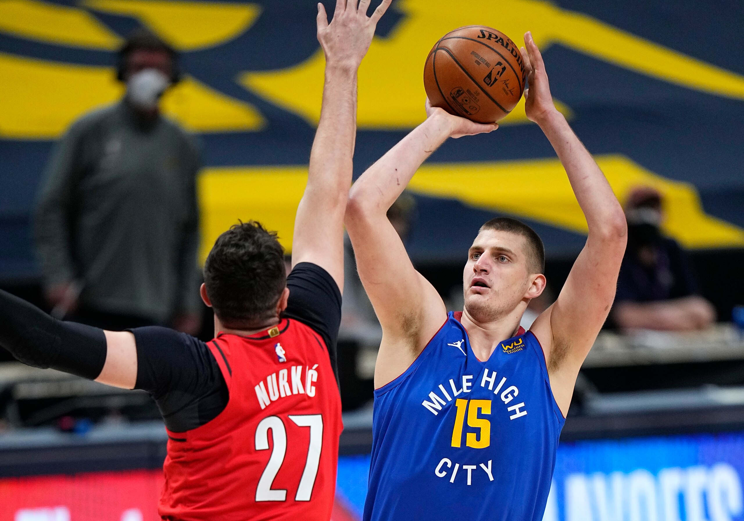 Denver Nuggets center Nikola Jokic (15) shoots against Portland Trail Blazers center Jusuf Nurkic (27) during the first half of Game 5 of a first-round NBA basketball playoff series Tuesday, June 1, 2021, in Denver. (AP Photo/Jack Dempsey)