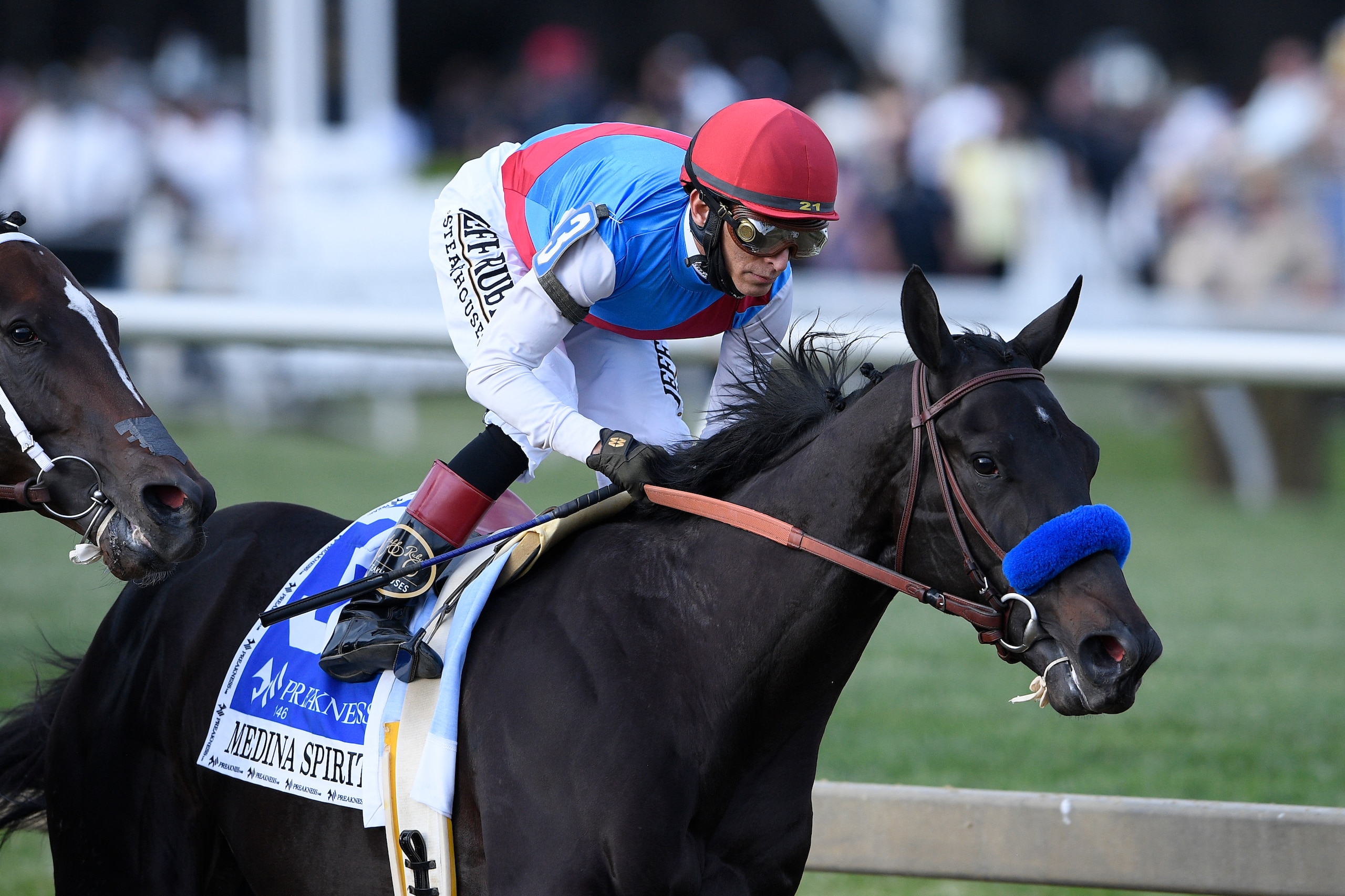 John Velazquez atop Medina Spirit runs in the Preakness Stakes horse race at Pimlico Race Course, Saturday, May 15, 2021, in Baltimore. (AP Photo/Nick Wass)