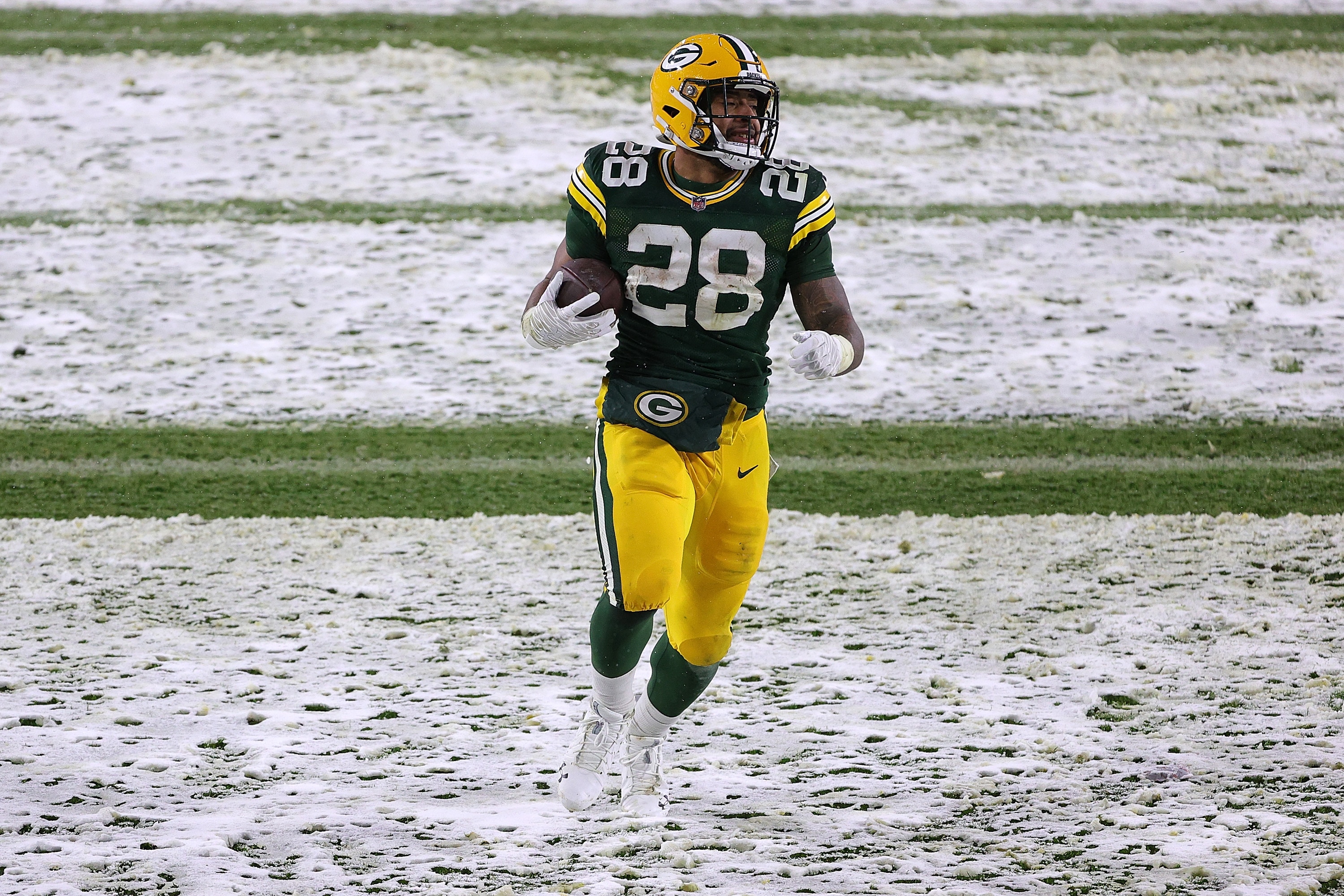 GREEN BAY, WISCONSIN - DECEMBER 27: A.J. Dillon #28 of the Green Bay Packers rushes for a touchdown during a game against the Tennessee Titans at Lambeau Field on December 27, 2020 in Green Bay, Wisconsin. (Photo by Stacy Revere/Getty Images)
