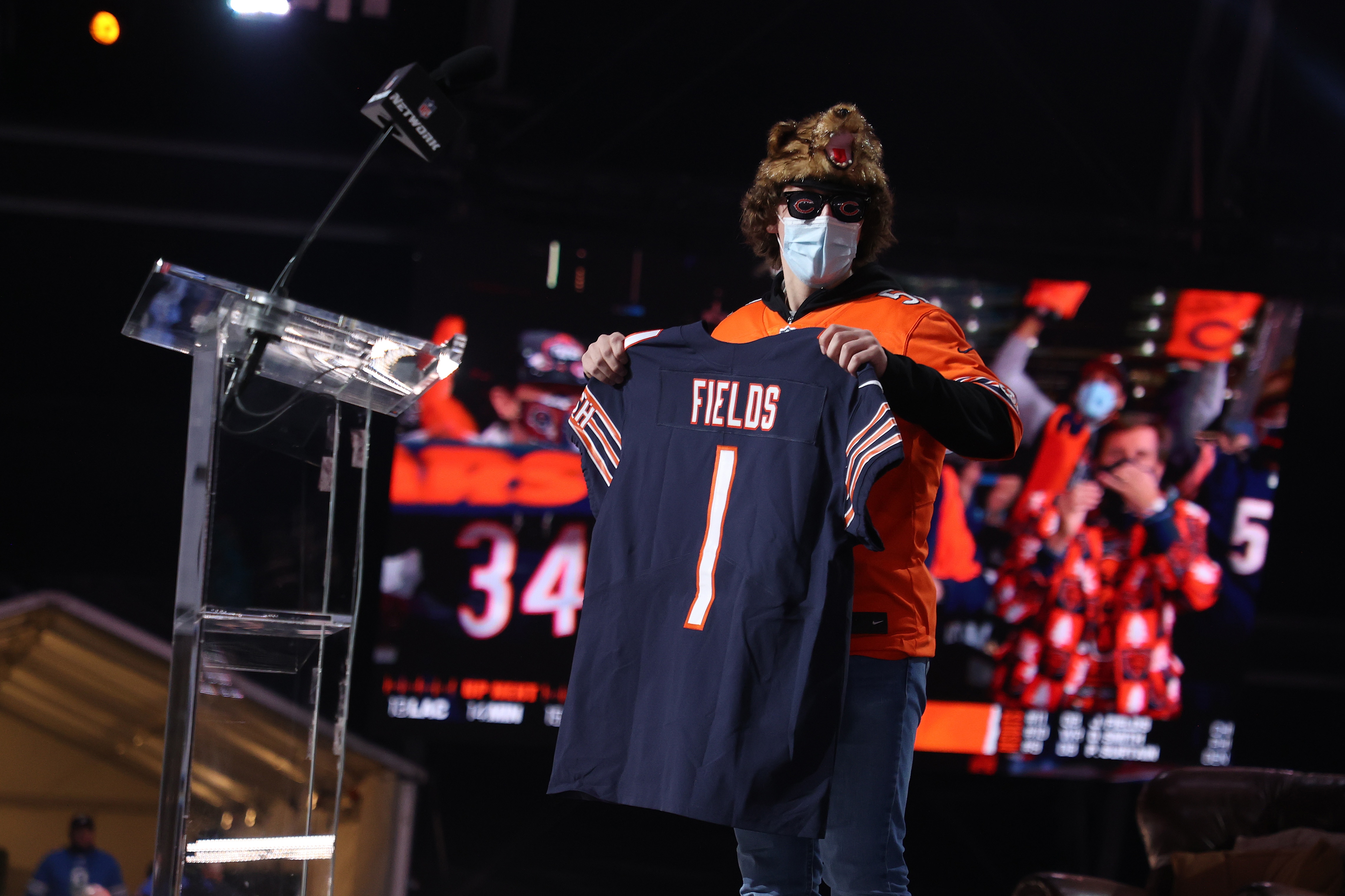 CLEVELAND, OHIO - APRIL 29: A fan holds a jersey after NFL Commissioner Roger Goodell announced Justin Fields being selected 11th by the Chicago Bears during round one of the 2021 NFL Draft at the Great Lakes Science Center on April 29, 2021 in Cleveland, Ohio. (Photo by Gregory Shamus/Getty Images)