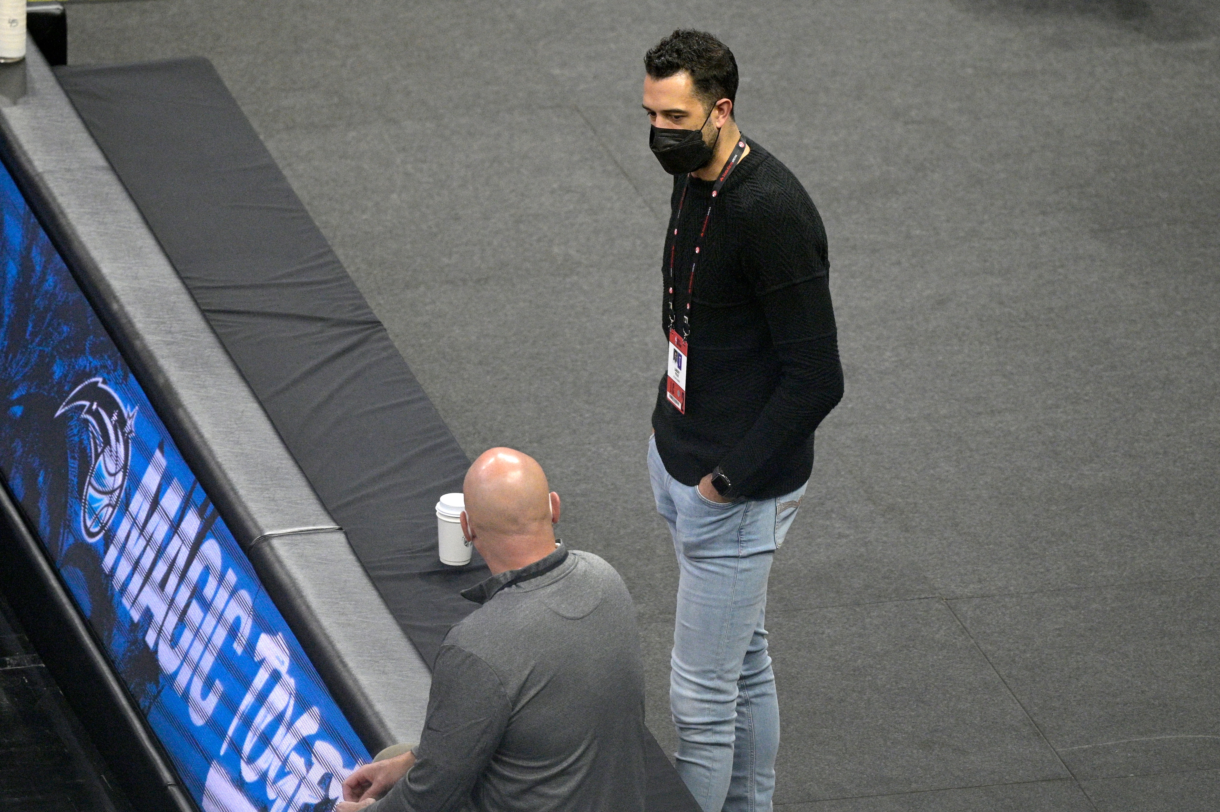 Atlanta Hawks assistant general manager Landry Fields, right, watches warmups before an NBA basketball game against the Orlando Magic, Wednesday, March 3, 2021, in Orlando, Fla. (AP Photo/Phelan M. Ebenhack)