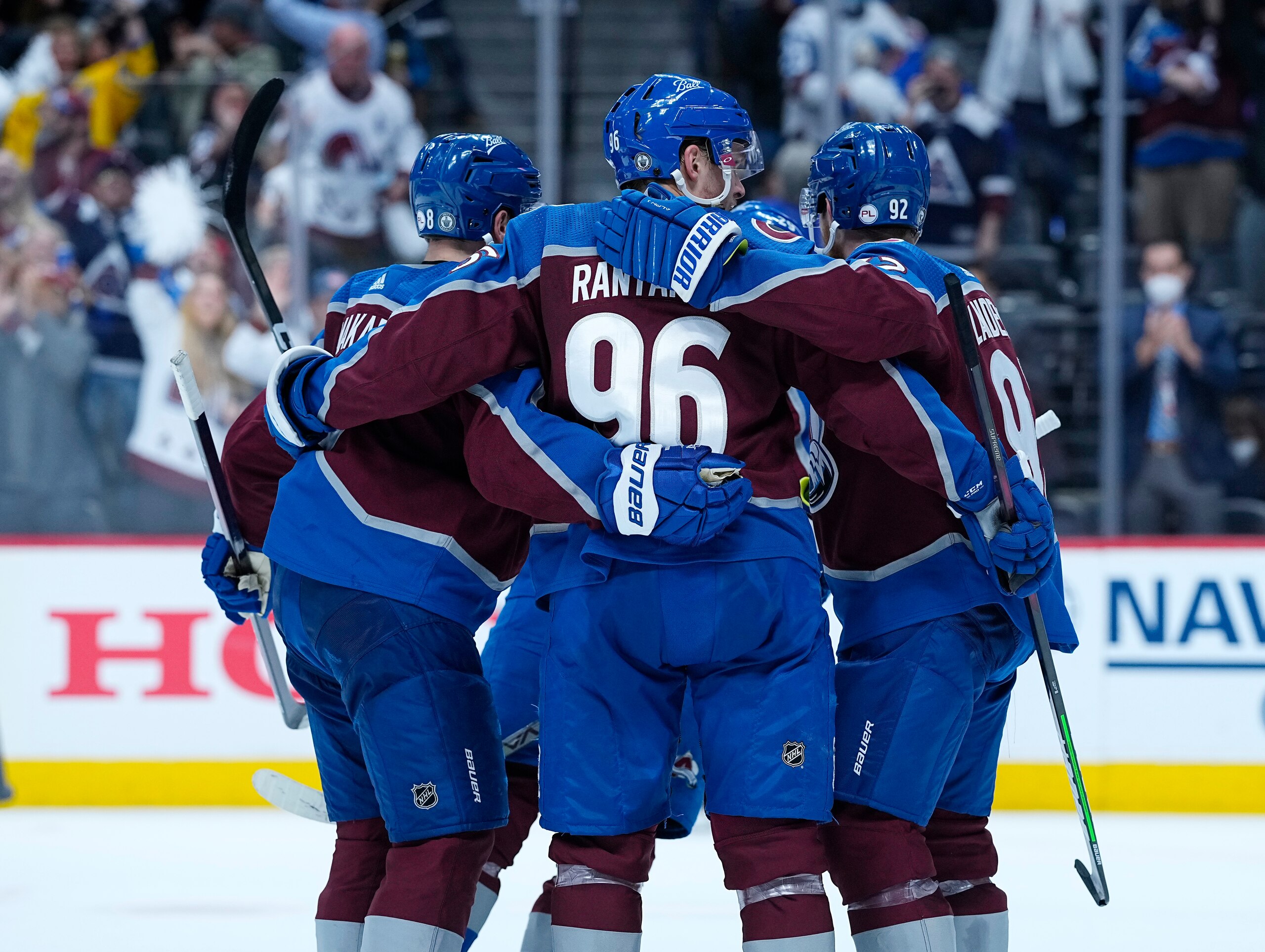 Colorado Avalanche left wing Gabriel Landeskog (92) is congratulated by teammates Cale Makar (8) and Mikko Rantanen (96) after scoring a goal against the Vegas Golden Knights in the second period of Game 1 of an NHL hockey Stanley Cup second-round playoff series Sunday, May 30, 2021, in Denver. (AP Photo/Jack Dempsey)