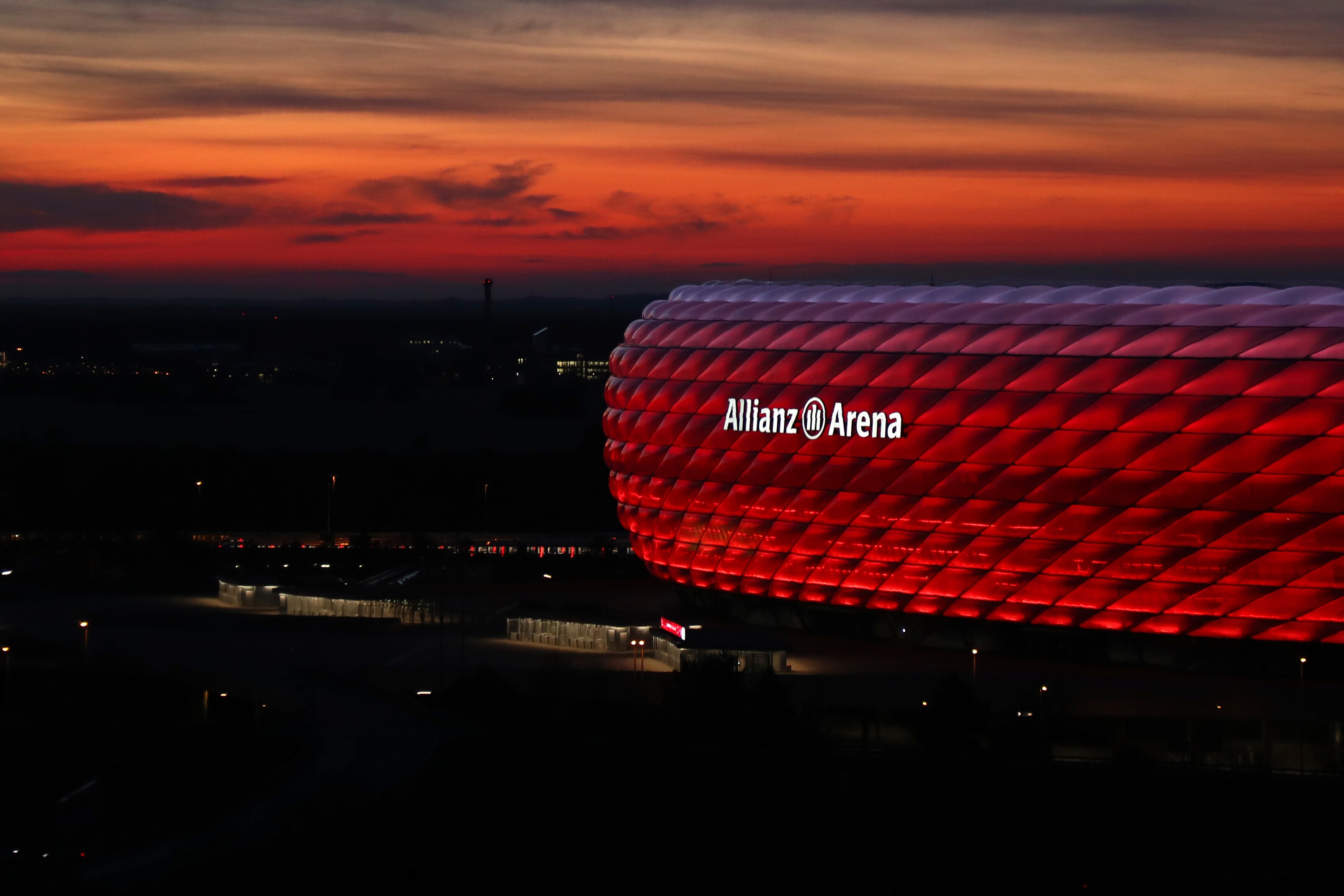 FILE - In this Monday, March 16, 2020 file photo, the sun sets behind the illuminated 'Allianz Arena' soccer stadium in Munich, Germany. England's only major tournament victory came when it won the 1966 World Cup at home. So could this finally be the year the team stops that seemingly endless barren spell? If they get that far, England will have home advantage for the semifinals and the final after playing its three group matches at Wembley Stadium. But the Netherlands and Germany have all their group games at home as well, and the Germans could also potentially play a quarterfinal match in Munich. (AP Photo/Matthias Schrader, File)