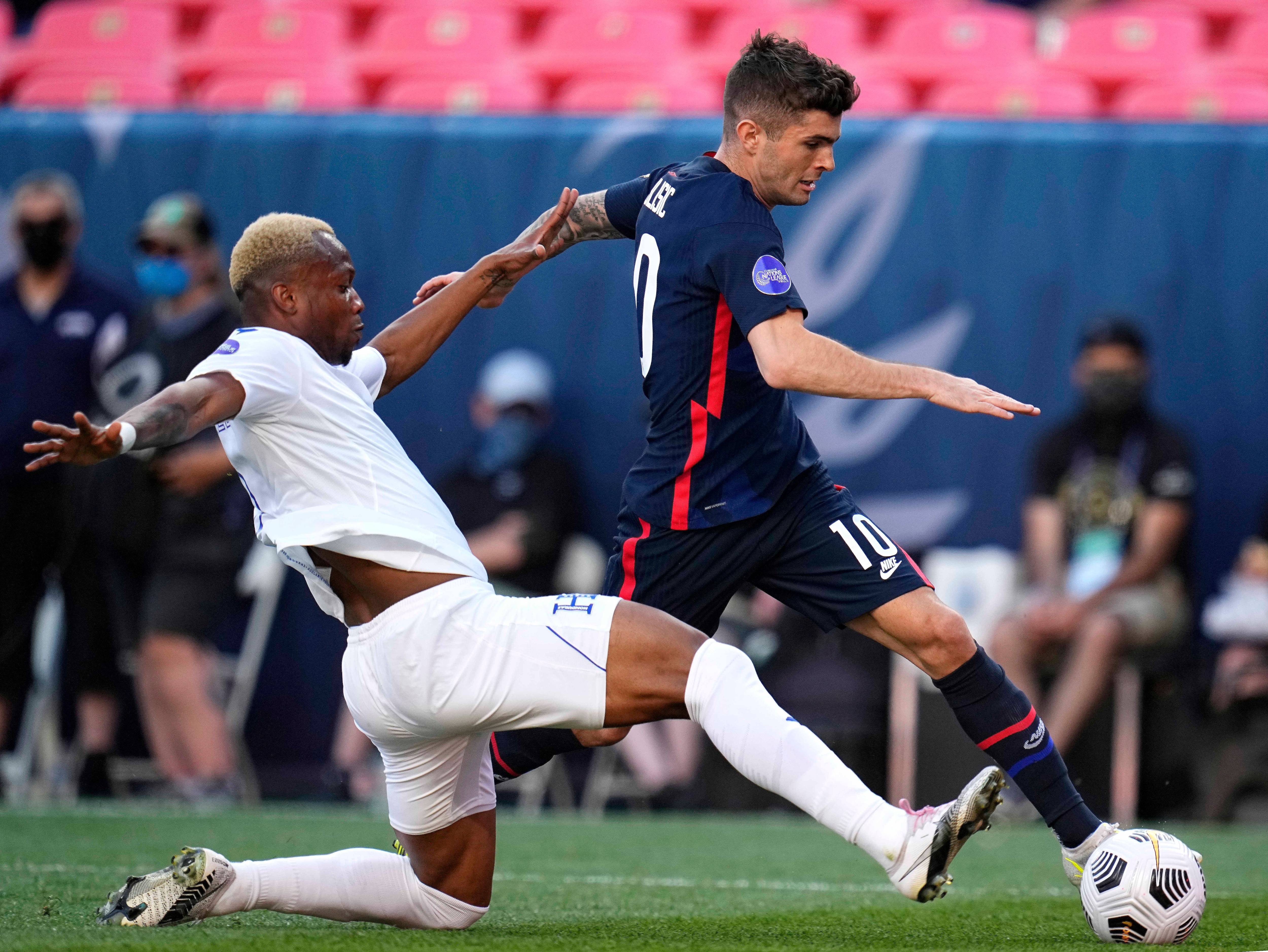 United States' Christian Pulisic (10) moves the ball against Honduras' Kevin Álvarez during the first half of a CONCACAF Nations League soccer final Thursday, June 3, 2021, in Denver. (AP Photo/Jack Dempsey)