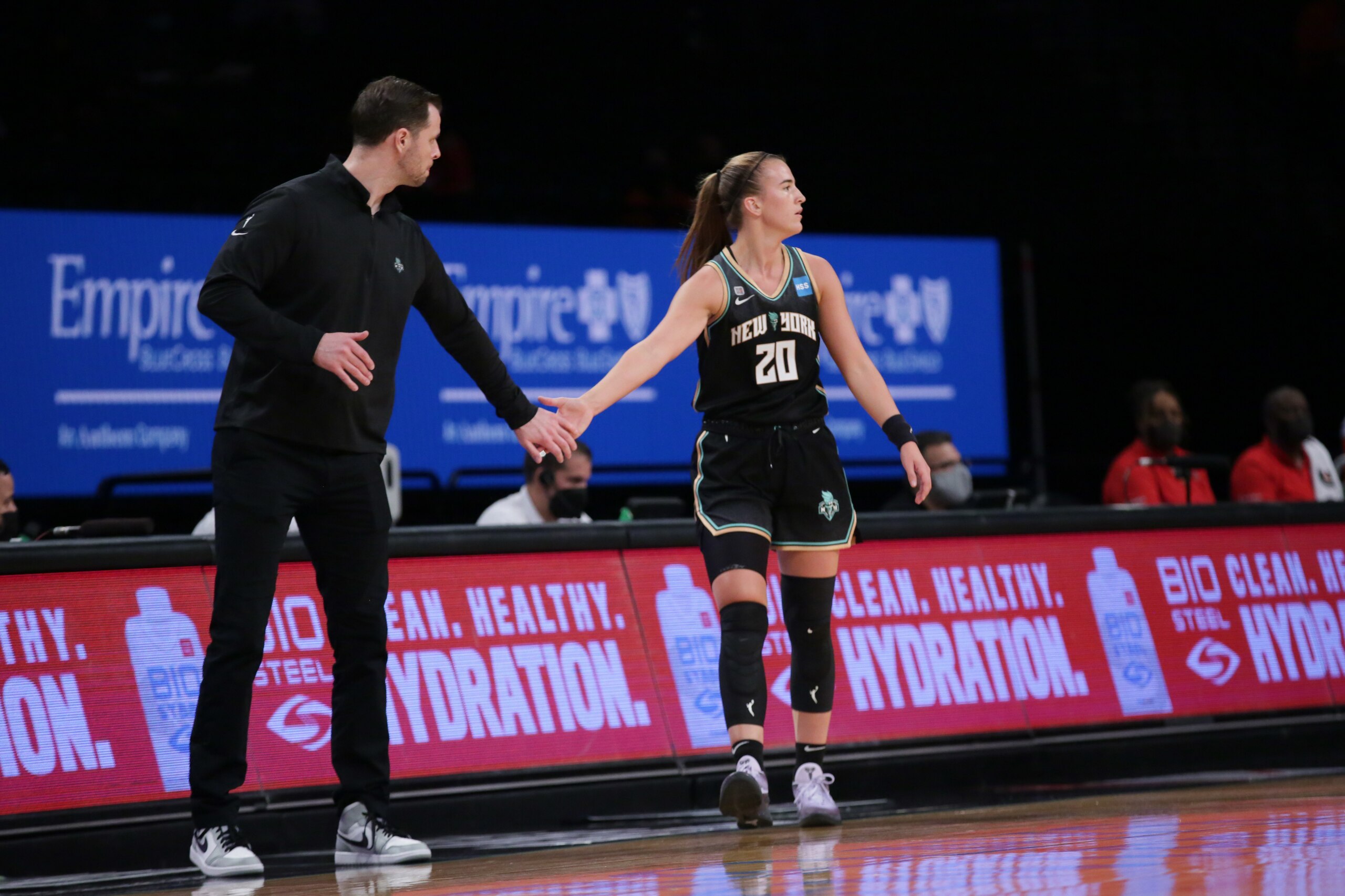 BROOKLYN, NY - MAY 29: Sabrina Ionescu #20 of the New York Liberty high fives her coach during the game against the Atlanta Dream on May 29, 2021 at Barclays Center in Brooklyn, New York. NOTE TO USER: User expressly acknowledges and agrees that, by downloading and or using this photograph, User is consenting to the terms and conditions of the Getty Images License Agreement. Mandatory Copyright Notice: Copyright 2021 NBAE (Photo by Steven Freeman/NBAE via Getty Images)