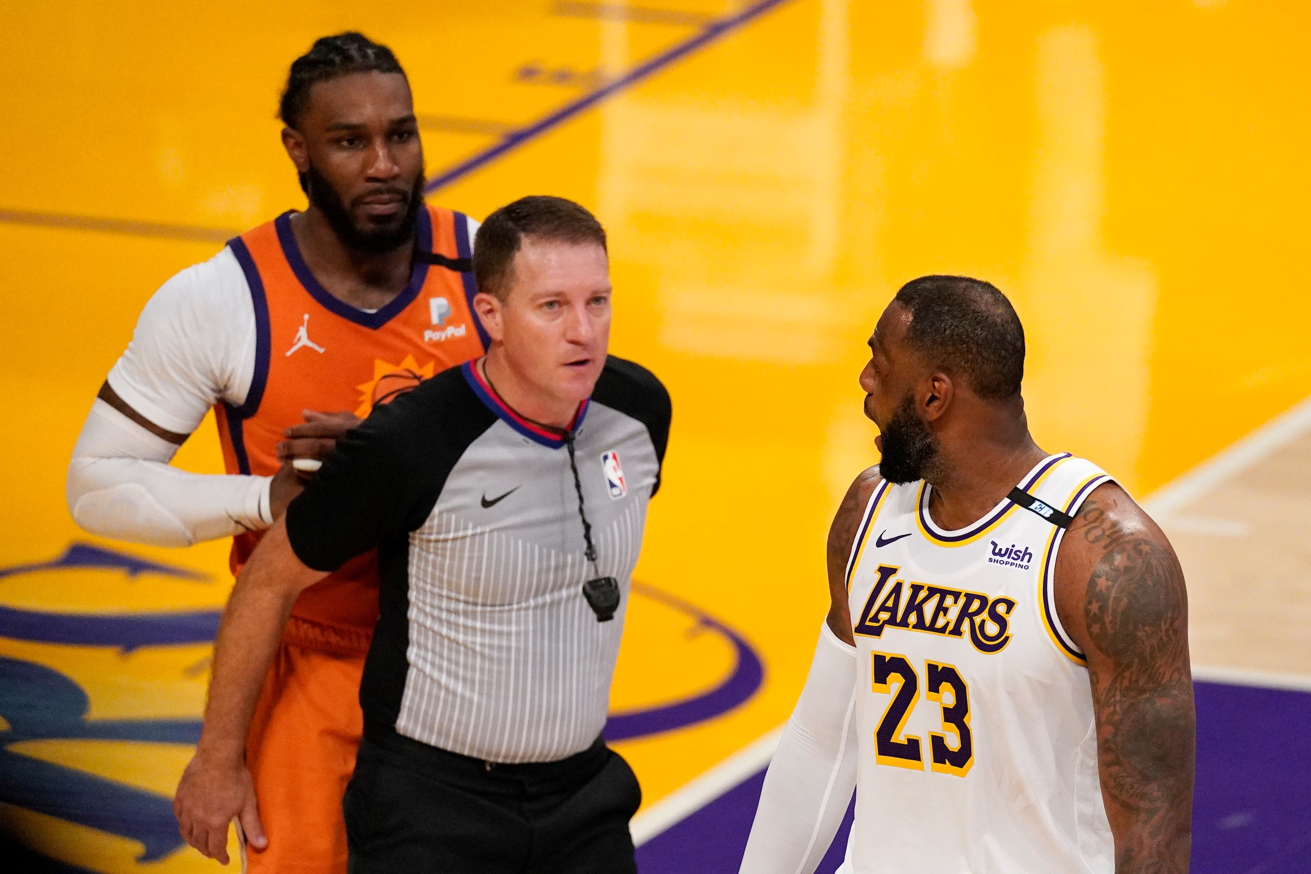 Phoenix Suns forward Jae Crowder, left, and Los Angeles Lakers forward LeBron James, right, exchange words after James was fouled as referee Brent Barnaky keep them apart during the second half in Game 4 of an NBA basketball first-round playoff series Sunday, May 30, 2021, in Los Angeles. (AP Photo/Mark J. Terrill)