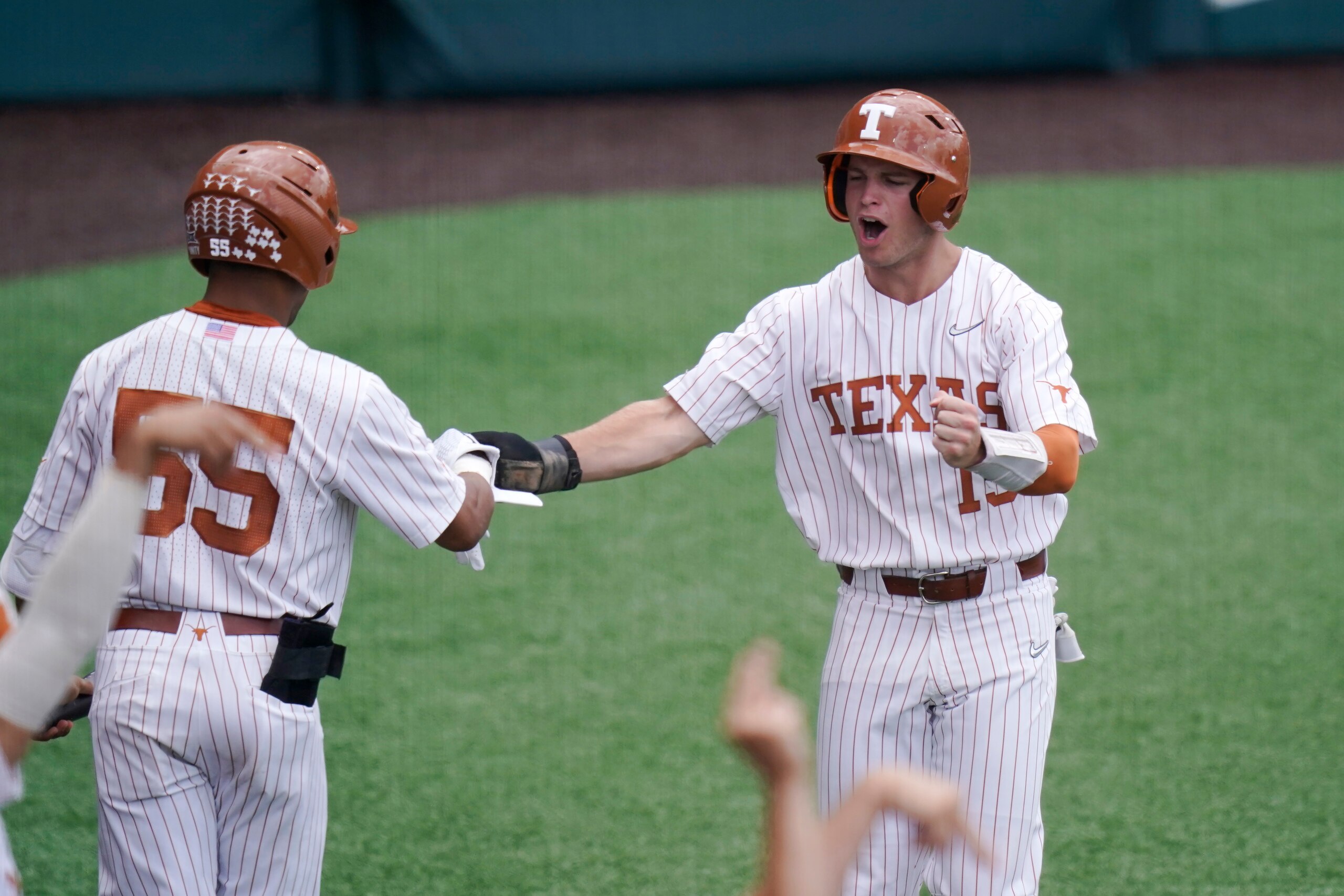 Texas infielder Mitchell Daly (19) celebrates with teammate Texas infielder Camryn Williams (55) after he scored against Southern in the third inning of an NCAA regional tournament college baseball game, Friday, June 4, 2021, in Austin, Texas. (AP Photo/Eric Gay)