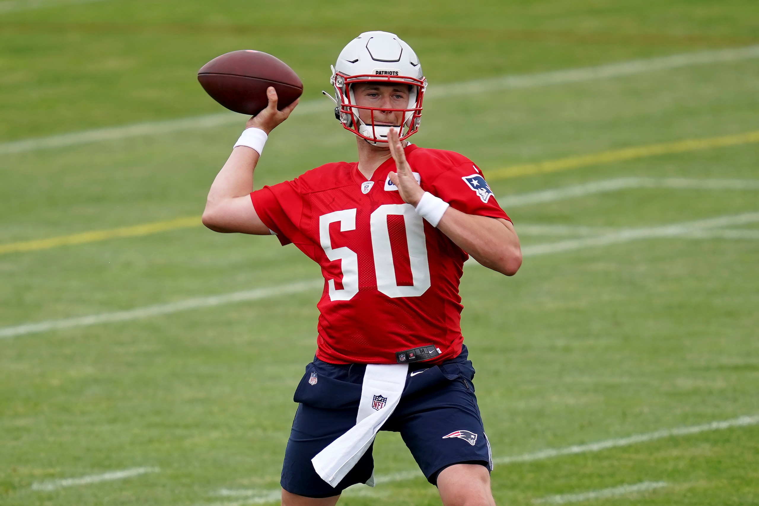 New England Patriots quarterback Mac Jones throws a pass during NFL football practice in Foxborough, Mass., Friday, June 4, 2021. (AP Photo/Mary Schwalm) New England Patriots quarterback Mac Jones throws a pass during NFL football practice in Foxborough, Mass., Friday, June 4, 2021. (AP Photo/Mary Schwalm)