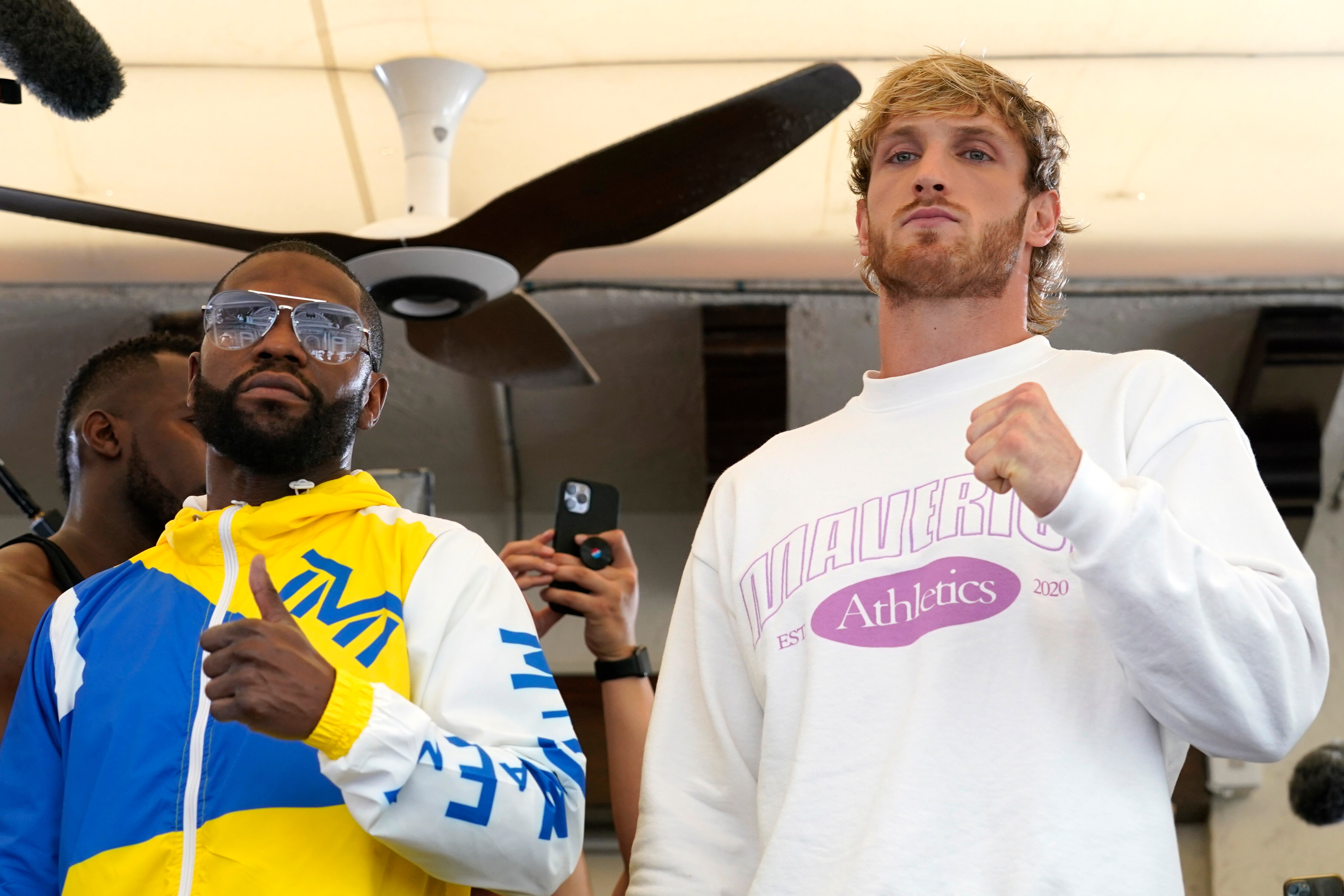 Floyd Mayweather, left, and Logan Paul, right, pose for a photograph during a press event, Thursday, June 3, 2021, in Miami Beach, Fla. Mayweather will fight Paul in an exhibition boxing match at the Hard Rock Stadium in Miami Gardens, Fla. Sunday. (AP Photo/Lynne Sladky)
