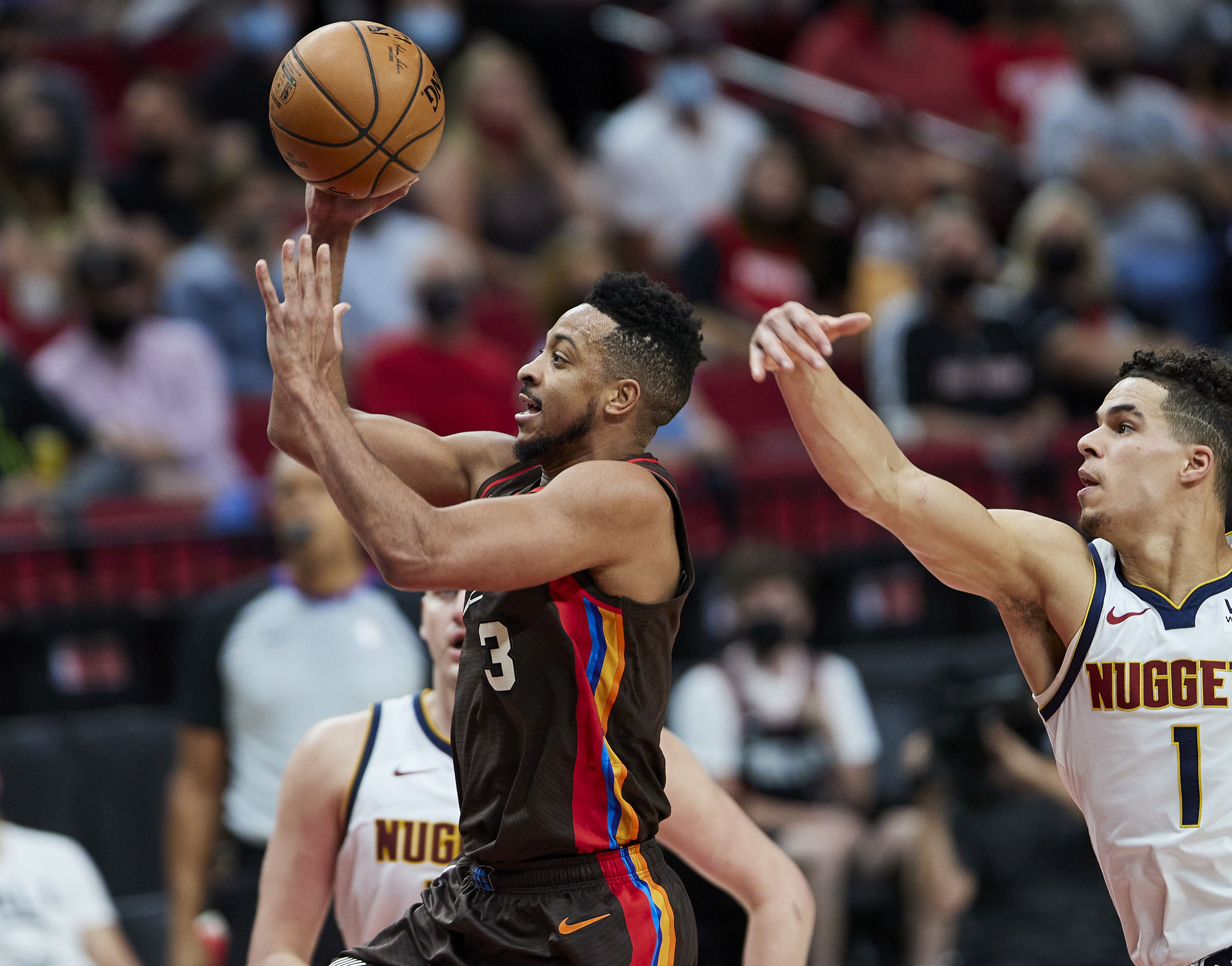 Portland Trail Blazers guard CJ McCollum shoots in front of Denver Nuggets forward Michael Porter Jr. during the second half of Game 6 of an NBA basketball first-round playoff series Thursday, June 3, 2021, in Portland, Ore. (AP Photo/Craig Mitchelldyer)