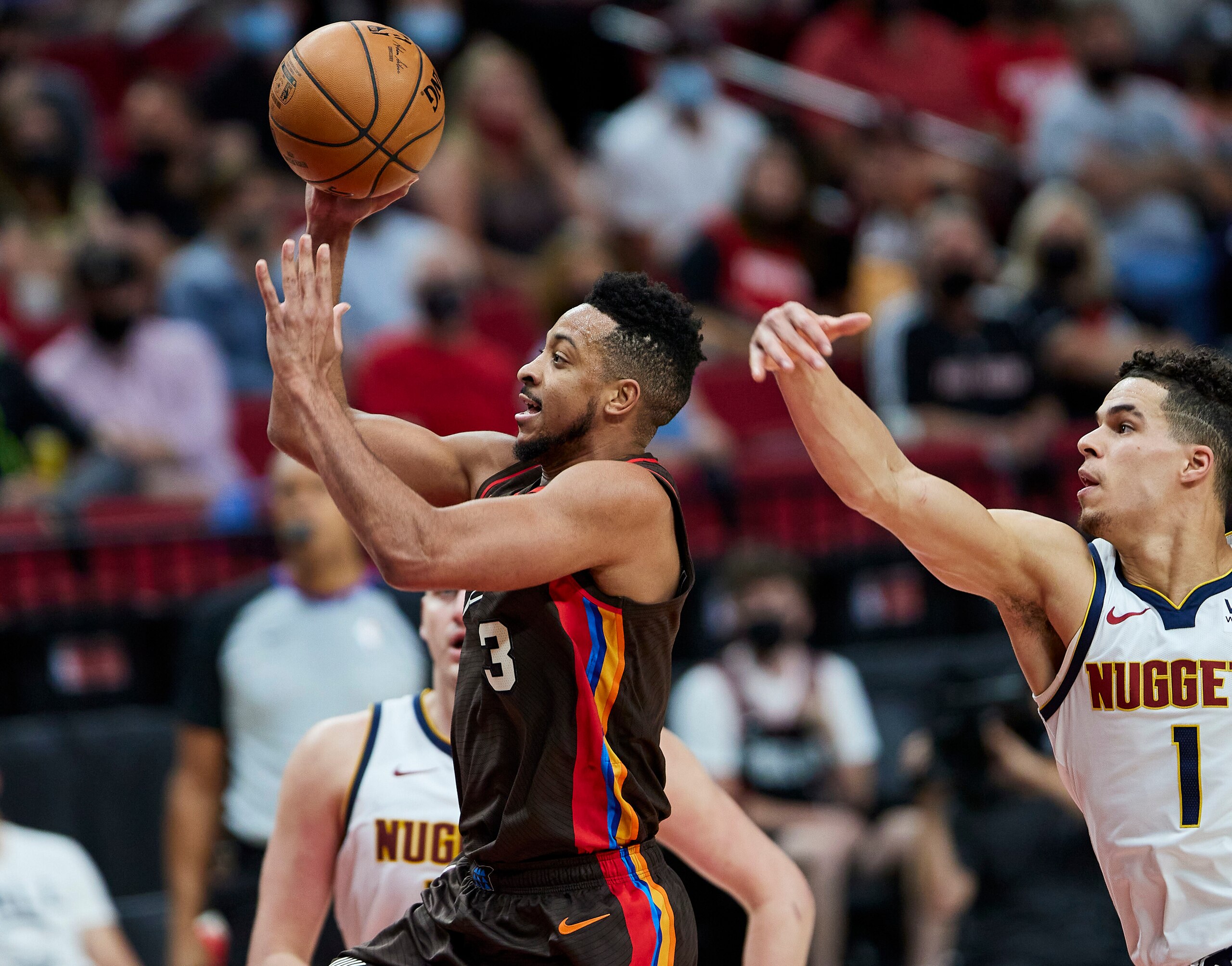 Portland Trail Blazers guard CJ McCollum shoots in front of Denver Nuggets forward Michael Porter Jr. during the second half of Game 6 of an NBA basketball first-round playoff series Thursday, June 3, 2021, in Portland, Ore. (AP Photo/Craig Mitchelldyer)
