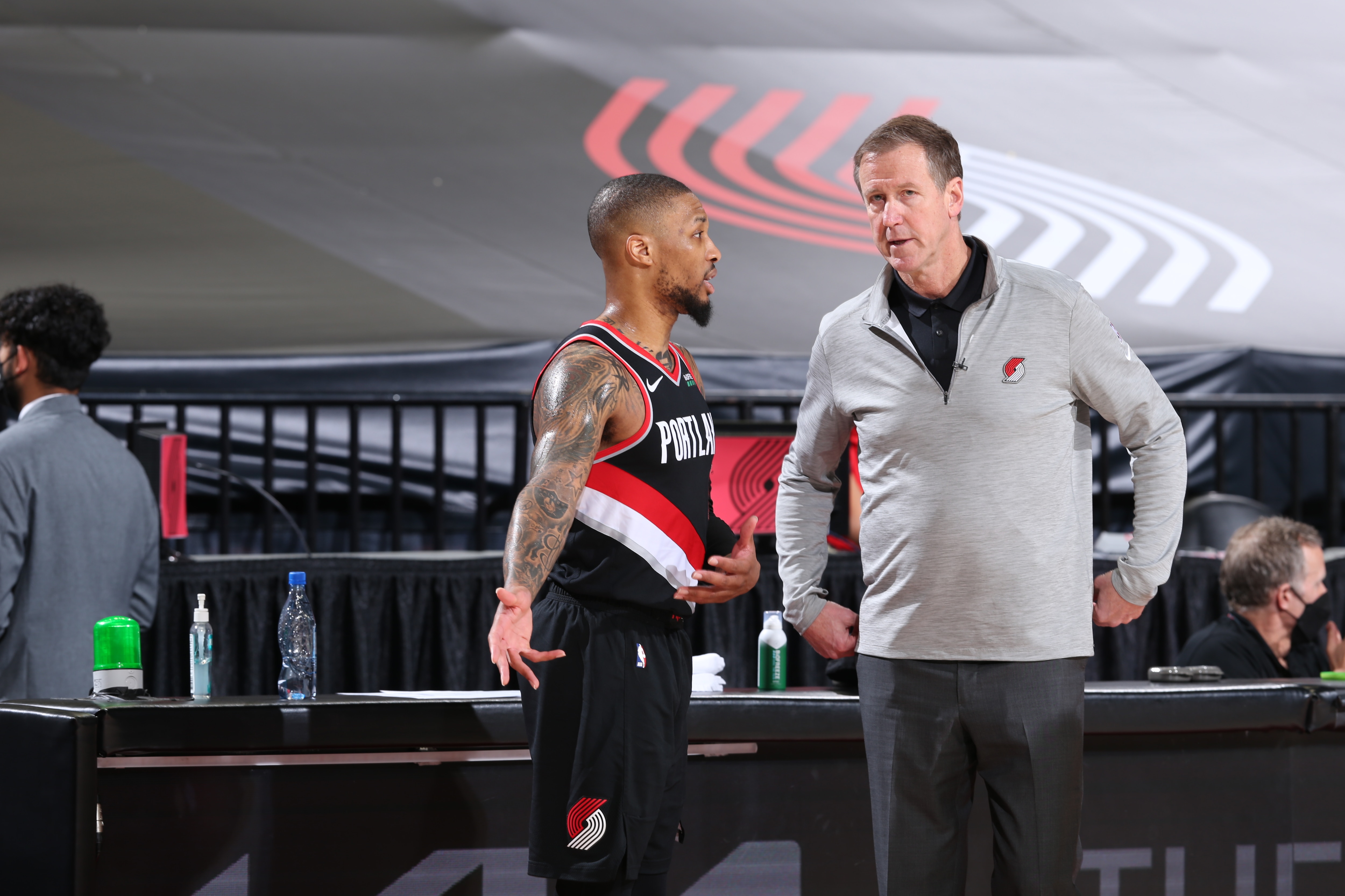 PORTLAND, OR - MAY 29: Damian Lillard #0 and Head Coach, Terry Stotts of the Portland Trail Blazers share a conversation during the game against the Denver Nuggets during Round 1, Game 4 of the 2021 NBA Playoffs on May 29, 2021 at the Moda Center Arena in Portland, Oregon. NOTE TO USER: User expressly acknowledges and agrees that, by downloading and or using this photograph, user is consenting to the terms and conditions of the Getty Images License Agreement. Mandatory Copyright Notice: Copyright 2021 NBAE (Photo by Sam Forencich/NBAE via Getty Images)