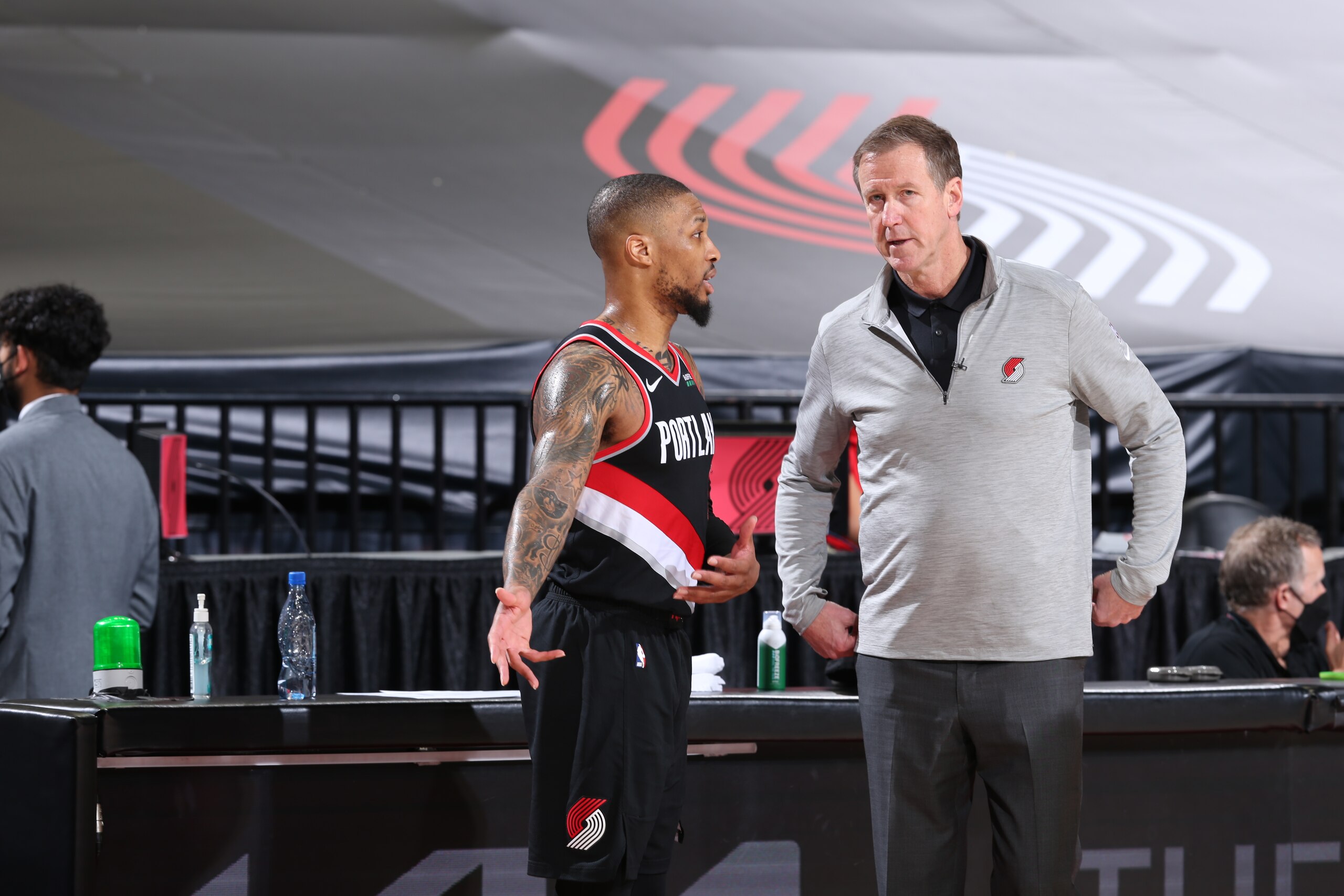 PORTLAND, OR - MAY 29: Damian Lillard #0 and Head Coach, Terry Stotts of the Portland Trail Blazers share a conversation during the game against the Denver Nuggets during Round 1, Game 4 of the 2021 NBA Playoffs on May 29, 2021 at the Moda Center Arena in Portland, Oregon. NOTE TO USER: User expressly acknowledges and agrees that, by downloading and or using this photograph, user is consenting to the terms and conditions of the Getty Images License Agreement. Mandatory Copyright Notice: Copyright 2021 NBAE (Photo by Sam Forencich/NBAE via Getty Images)