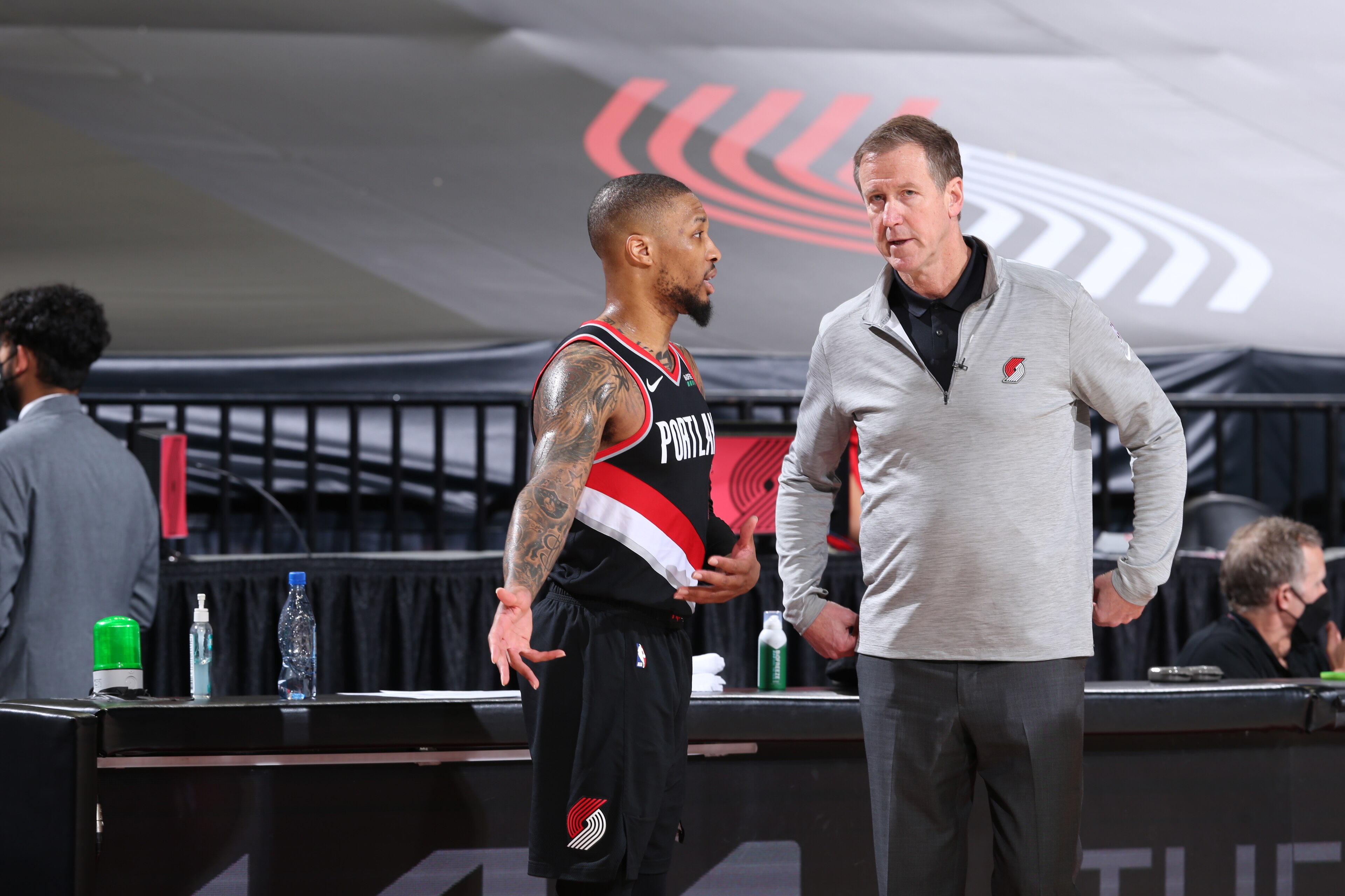 PORTLAND, OR - MAY 29: Damian Lillard #0 and Head Coach, Terry Stotts of the Portland Trail Blazers share a conversation during the game against the Denver Nuggets during Round 1, Game 4 of the 2021 NBA Playoffs on May 29, 2021 at the Moda Center Arena in Portland, Oregon. NOTE TO USER: User expressly acknowledges and agrees that, by downloading and or using this photograph, user is consenting to the terms and conditions of the Getty Images License Agreement. Mandatory Copyright Notice: Copyright 2021 NBAE (Photo by Sam Forencich/NBAE via Getty Images)