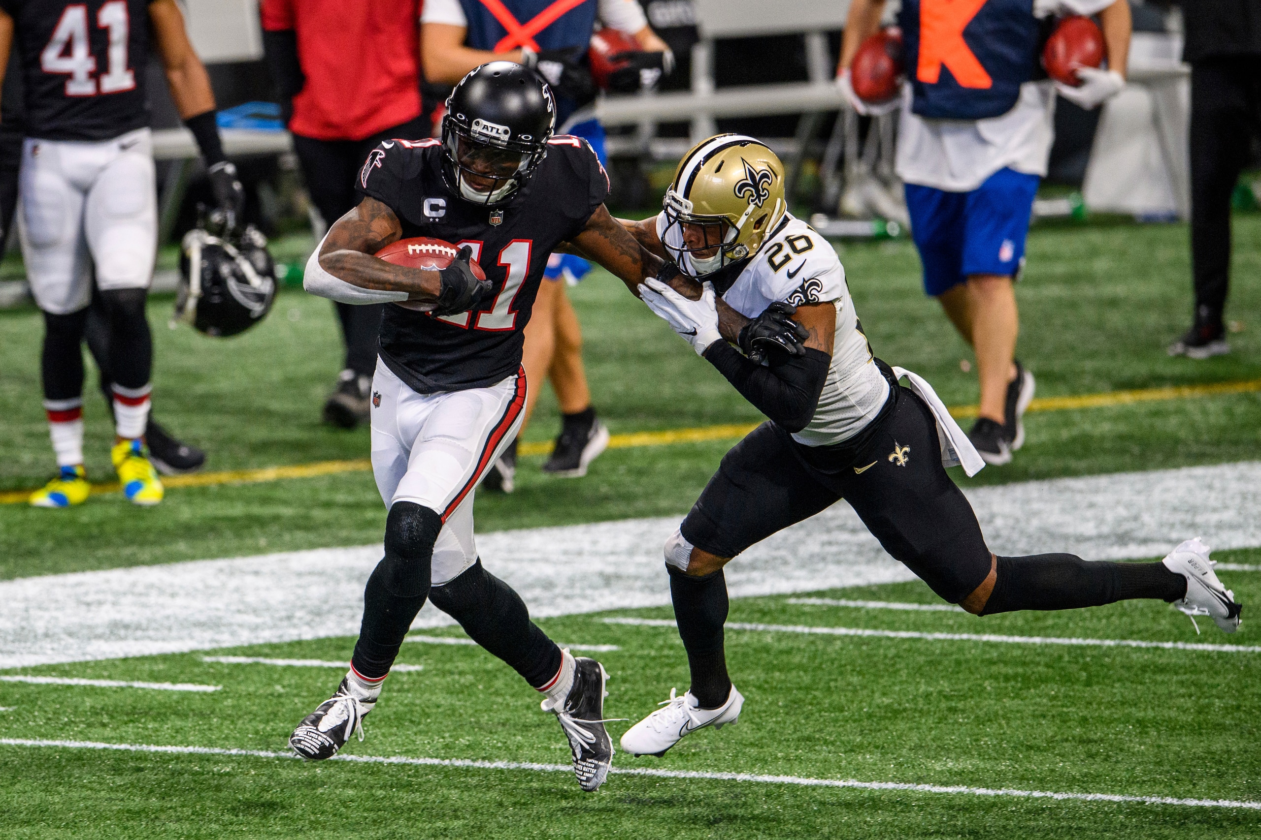 Atlanta Falcons wide receiver Julio Jones (11) runs the ball as New Orleans Saints cornerback P.J. Williams (26) defends during the first half of an NFL football game, Sunday, Dec. 6, 2020, in Atlanta. The New Orleans Saints won 21-16. (AP Photo/Danny Karnik) Atlanta Falcons wide receiver Julio Jones (11) runs the ball as New Orleans Saints cornerback P.J. Williams (26) defends during the first half of an NFL football game, Sunday, Dec. 6, 2020, in Atlanta. The New Orleans Saints won 21-16. (AP Photo/Danny Karnik)