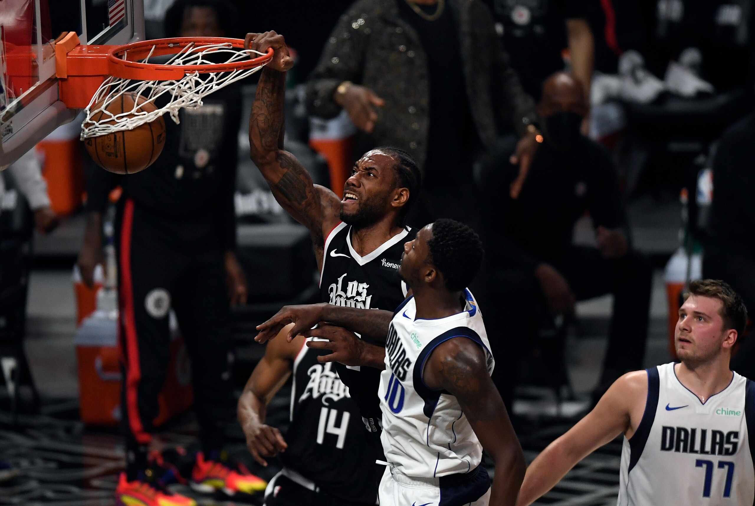 LOS ANGELES, CA - JUNE 06: Kawhi Leonard #2 of the Los Angeles Clippers dunks the ball against Dorian Finney-Smith #10 of the Dallas Mavericks during the first half of Game Seven of the Western Conference first round series at Staples Center on June 6, 2021 in Los Angeles, California. NOTE TO USER: User expressly acknowledges and agrees that, by downloading and or using this photograph, User is consenting to the terms and conditions of the Getty Images License Agreement. (Photo by Kevork Djansezian/Getty Images)
