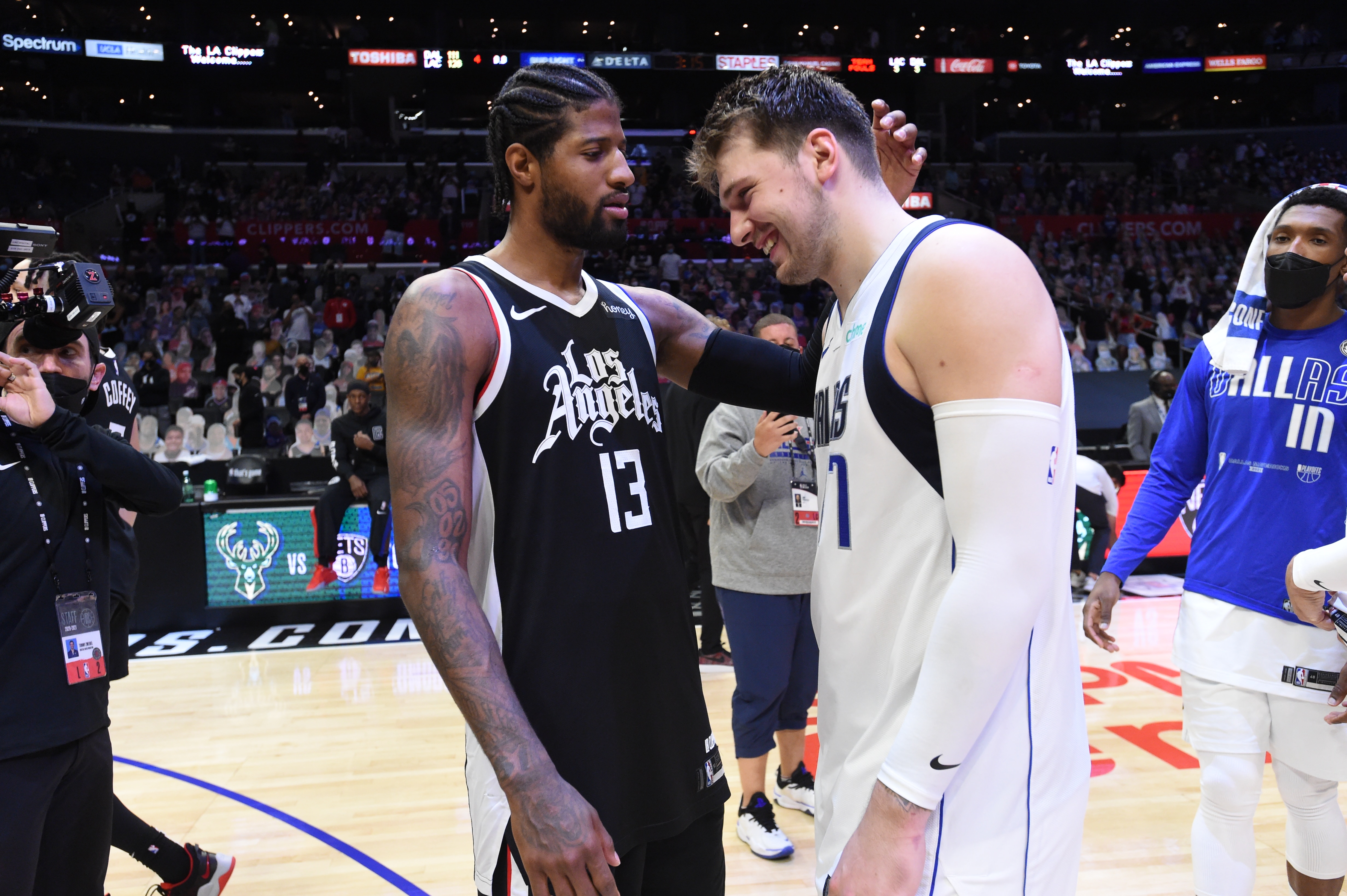 LOS ANGELES, CA - JUNE 6: Paul George #13 of the LA Clippers hugs Luka Doncic #77 of the Dallas Mavericks after Round 1, Game 7 of the 2021 NBA Playoffs on June 6, 2021 at STAPLES Center in Los Angeles, California. NOTE TO USER: User expressly acknowledges and agrees that, by downloading and/or using this Photograph, user is consenting to the terms and conditions of the Getty Images License Agreement. Mandatory Copyright Notice: Copyright 2021 NBAE (Photo by Juan Ocampo/NBAE via Getty Images) LOS ANGELES, CA - JUNE 6: Paul George #13 of the LA Clippers hugs Luka Doncic #77 of the Dallas Mavericks after Round 1, Game 7 of the 2021 NBA Playoffs on June 6, 2021 at STAPLES Center in Los Angeles, California. NOTE TO USER: User expressly acknowledges and agrees that, by downloading and/or using this Photograph, user is consenting to the terms and conditions of the Getty Images License Agreement. Mandatory Copyright Notice: Copyright 2021 NBAE (Photo by Juan Ocampo/NBAE via Getty Images)