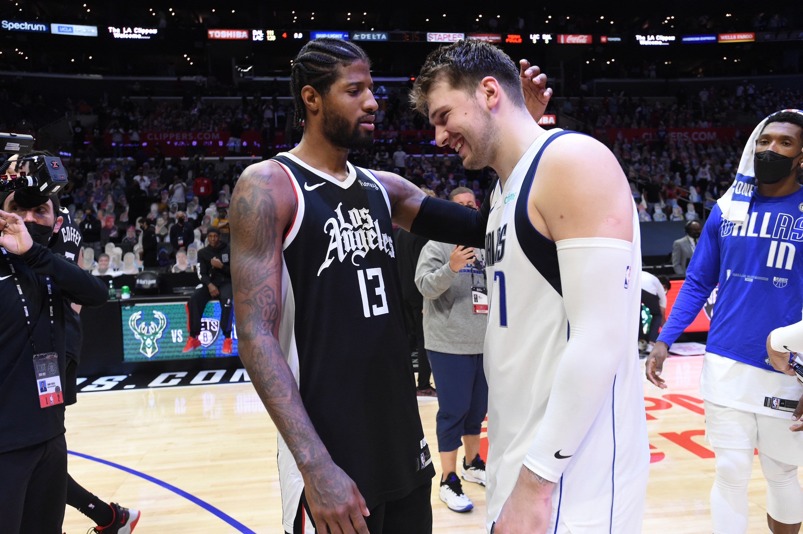 LOS ANGELES, CA - JUNE 6: Paul George #13 of the LA Clippers hugs Luka Doncic #77 of the Dallas Mavericks after Round 1, Game 7 of the 2021 NBA Playoffs on June 6, 2021 at STAPLES Center in Los Angeles, California. NOTE TO USER: User expressly acknowledges and agrees that, by downloading and/or using this Photograph, user is consenting to the terms and conditions of the Getty Images License Agreement. Mandatory Copyright Notice: Copyright 2021 NBAE (Photo by Juan Ocampo/NBAE via Getty Images)