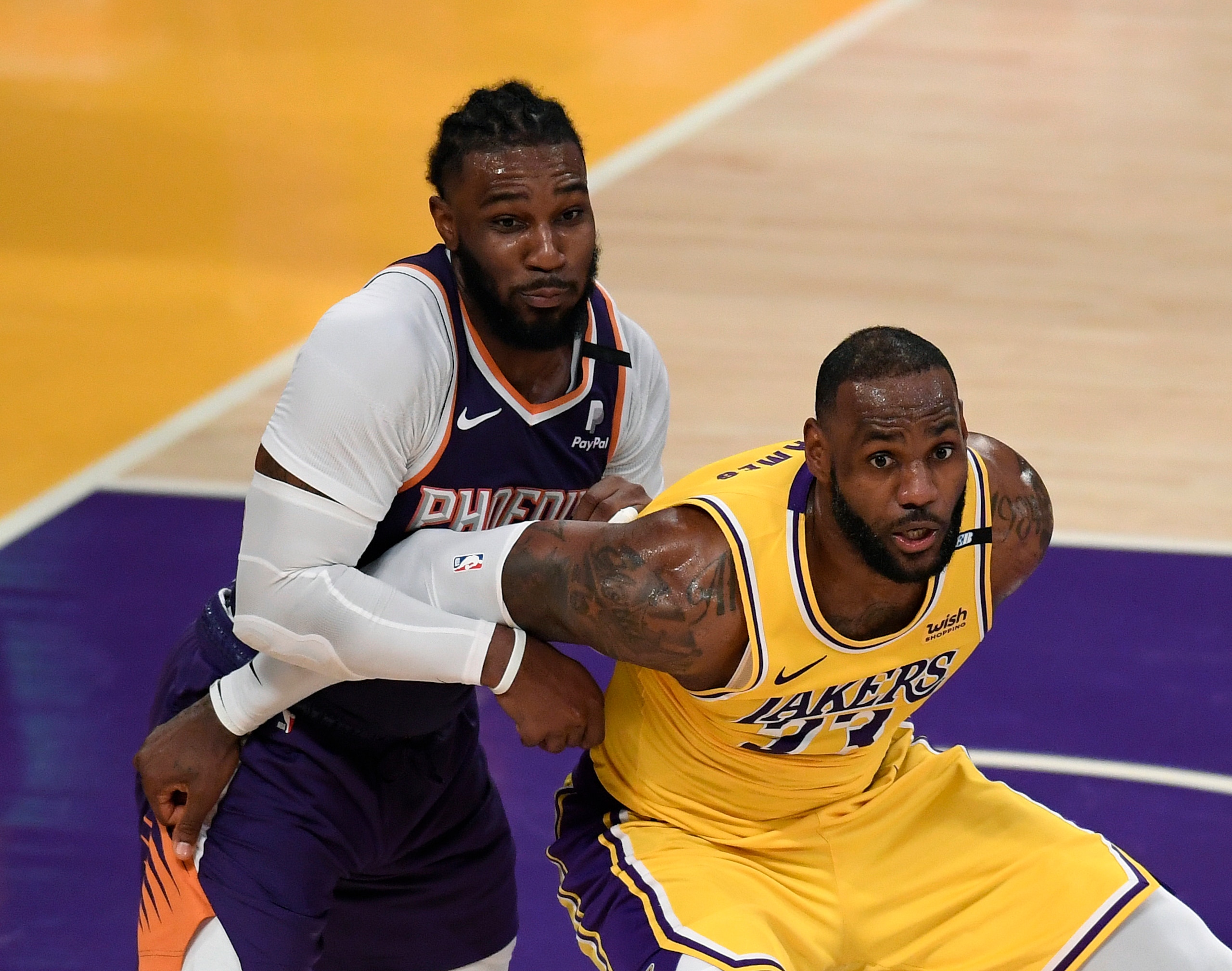 LOS ANGELES, CALIFORNIA - JUNE 03: LeBron James #23 of the Los Angeles Lakers fends off Jae Crowder #99 of the Phoenix Suns for position in the fourth quarter during game six of the Western Conference first round series at Staples Center on June 03, 2021 in Los Angeles, California. (Photo by Harry How/Getty Images) NOTE TO USER: User expressly acknowledges and agrees that, by downloading and or using this photograph, User is consenting to the terms and conditions of the Getty Images License Agreement.
