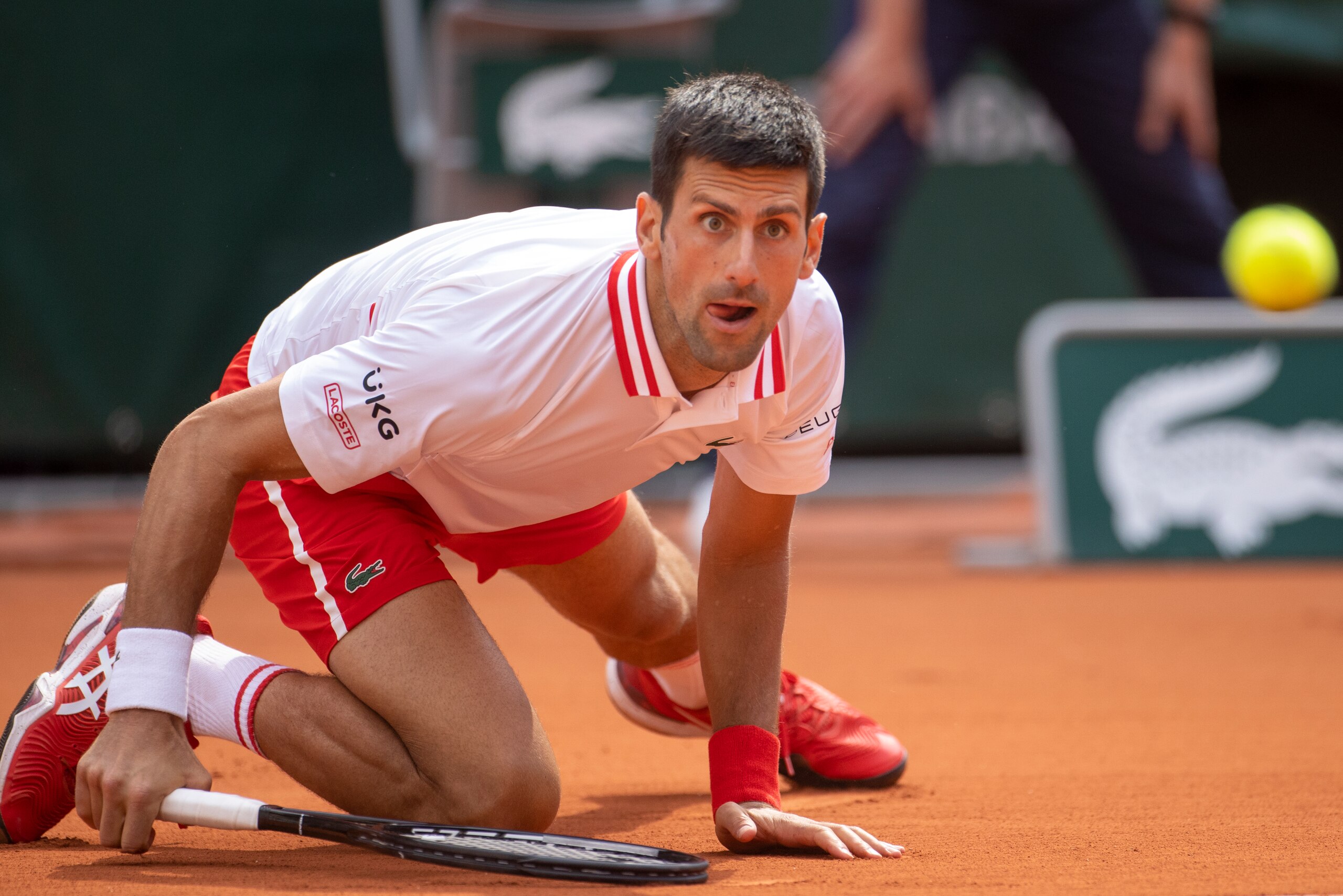 PARIS, FRANCE June 7. Novak Djokovic of Serbia slips at the start of the fifth set against Lorenzo Musetti of Italy on Court Philippe-Chatrier during the fourth round of the singles competition at the 2021 French Open Tennis Tournament at Roland Garros on June 7th 2021 in Paris, France. (Photo by Tim Clayton/Corbis via Getty Images) PARIS, FRANCE June 7. Novak Djokovic of Serbia slips at the start of the fifth set against Lorenzo Musetti of Italy on Court Philippe-Chatrier during the fourth round of the singles competition at the 2021 French Open Tennis Tournament at Roland Garros on June 7th 2021 in Paris, France. (Photo by Tim Clayton/Corbis via Getty Images)