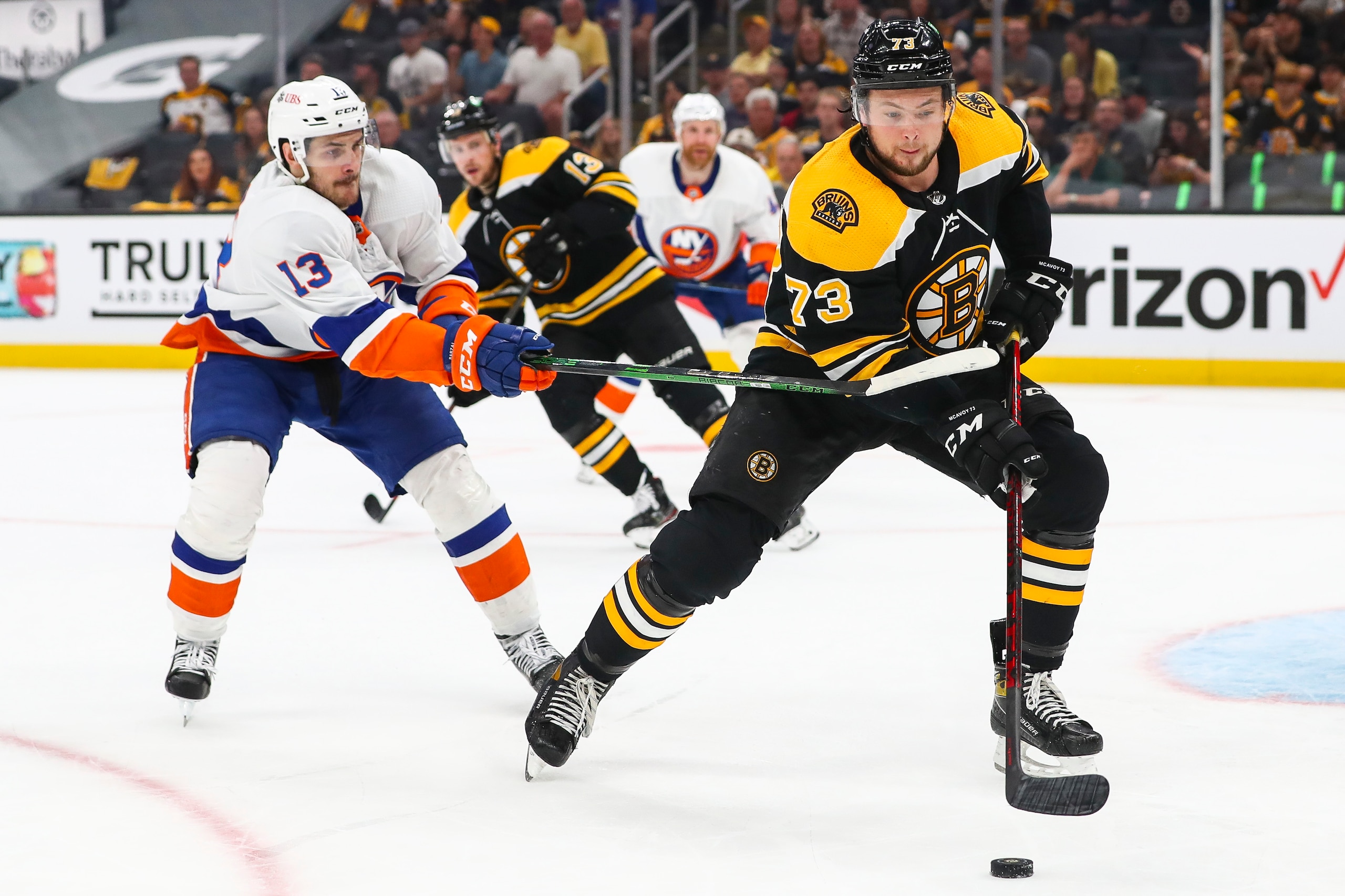 BOSTON, MA - JUNE 7: Charlie McAvoy #73 of the Boston Bruins and Mathew Barzal #13 of the New York Islanders fight for the puck in the second period in Game Five of the Second Round of the 2021 Stanley Cup Playoffs at TD Garden on June 7, 2021 in Boston, Massachusetts. (Photo by Adam Glanzman/Getty Images)