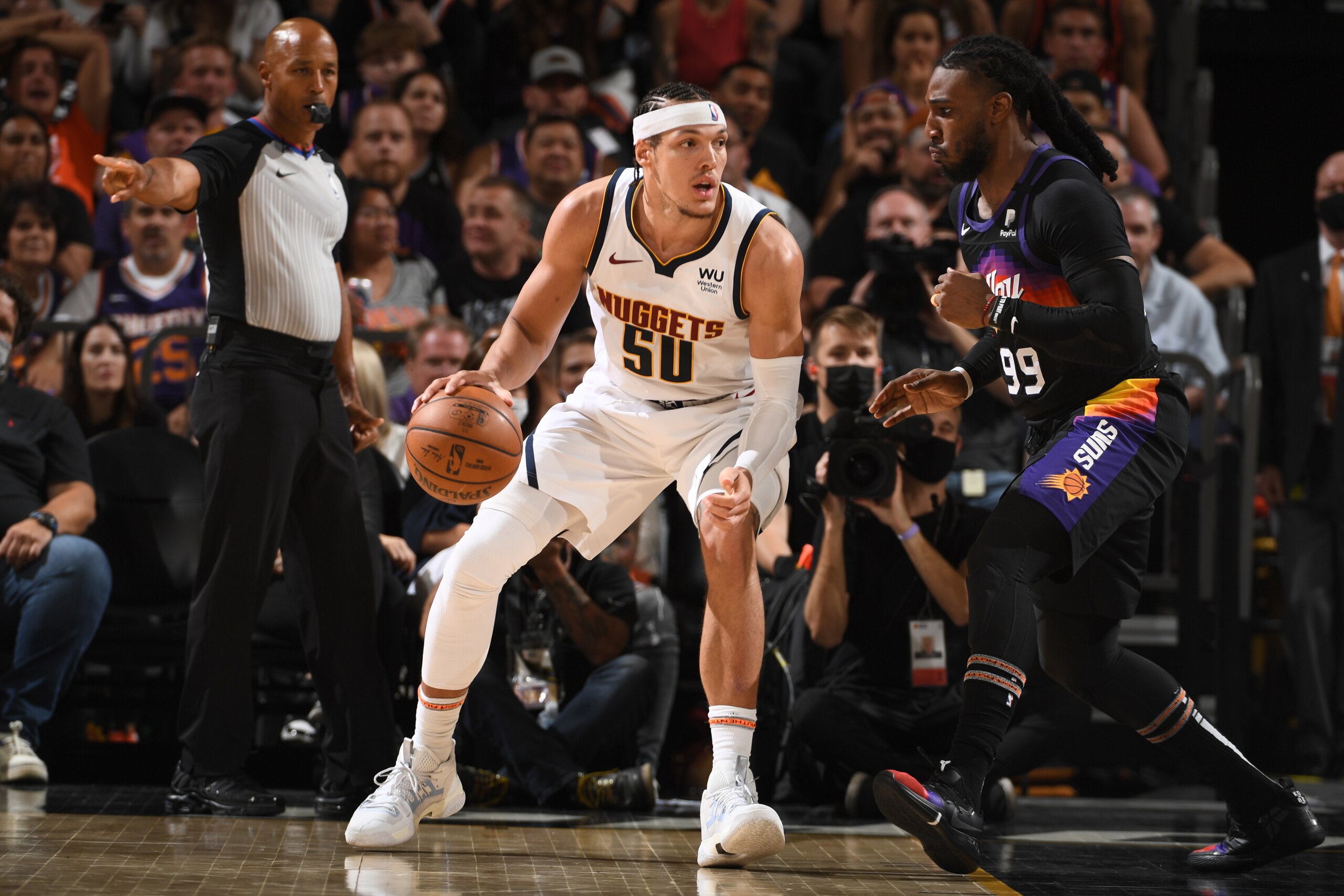 PHOENIX, AZ - JUNE 7: Jae Crowder #99 of the Phoenix Suns plays defense on Aaron Gordon #50 of the Denver Nuggets during Round 2, Game 1 of the 2021 NBA Playoffs on June 7, 2021 at Phoenix Suns Arena in Phoenix, Arizona. NOTE TO USER: User expressly acknowledges and agrees that, by downloading and/or using this Photograph, user is consenting to the terms and conditions of the Getty Images License Agreement. Mandatory Copyright Notice: Copyright 2021 NBAE (Photo by Garrett Ellwood/NBAE via Getty Images)