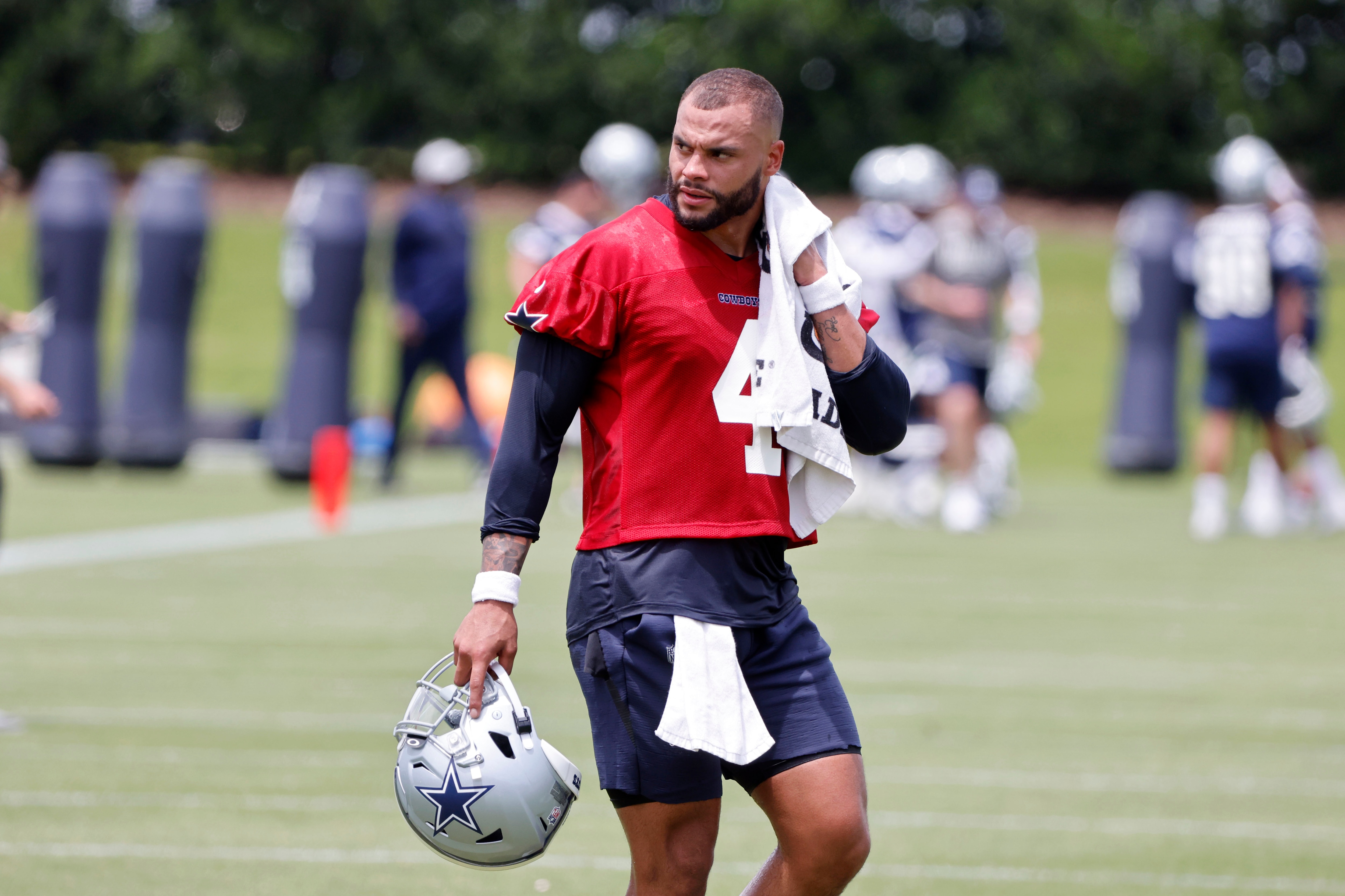 Dallas Cowboys quarterback Dak Prescott (4) cools off during NFL football practice in Frisco, Texas, Thursday, June 3, 2021. (AP Photo/Michael Ainsworth)
