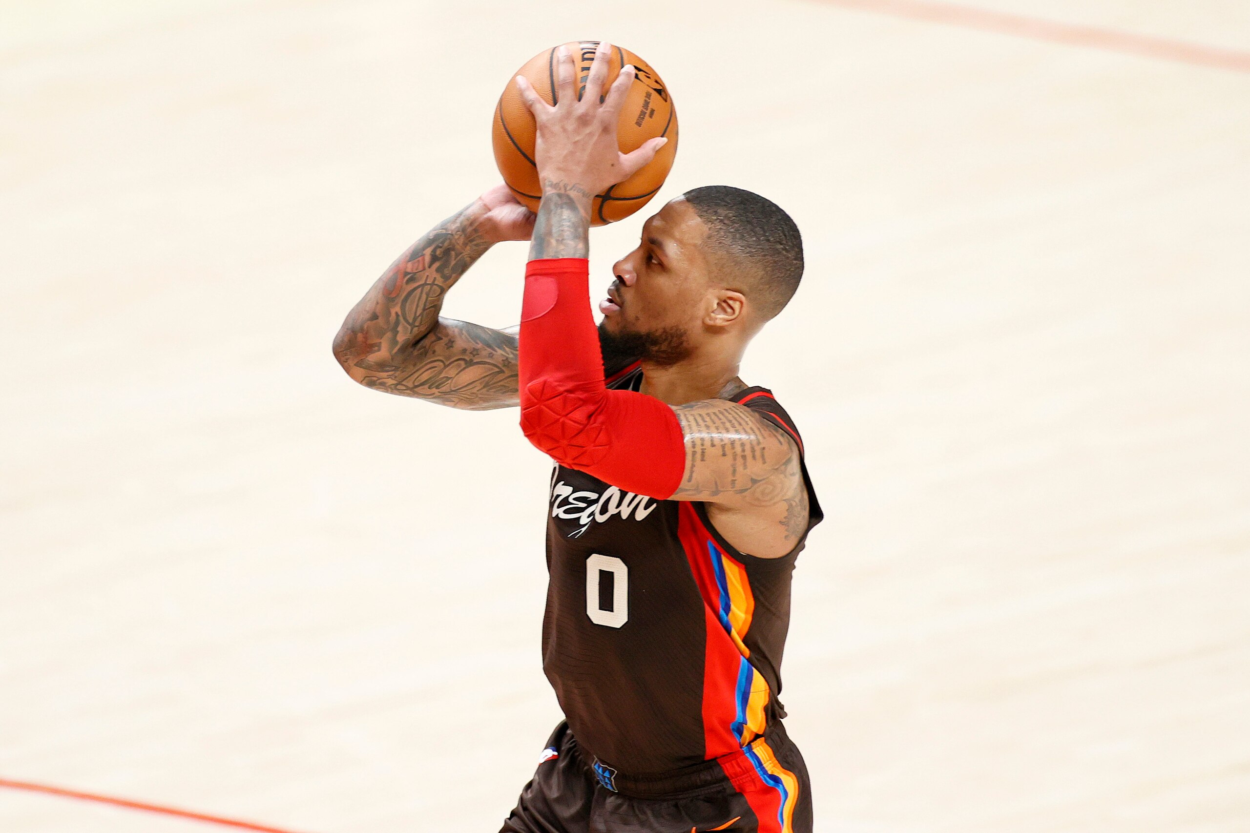 PORTLAND, OREGON - JUNE 03: Damian Lillard #0 of the Portland Trail Blazers attempts a three point basket against the Denver Nuggets during Round 1, Game 6 of the 2021 NBA Playoffs at Moda Center on June 03, 2021 in Portland, Oregon. NOTE TO USER: User expressly acknowledges and agrees that, by downloading and or using this photograph, User is consenting to the terms and conditions of the Getty Images License Agreement. (Photo by Steph Chambers/Getty Images)
