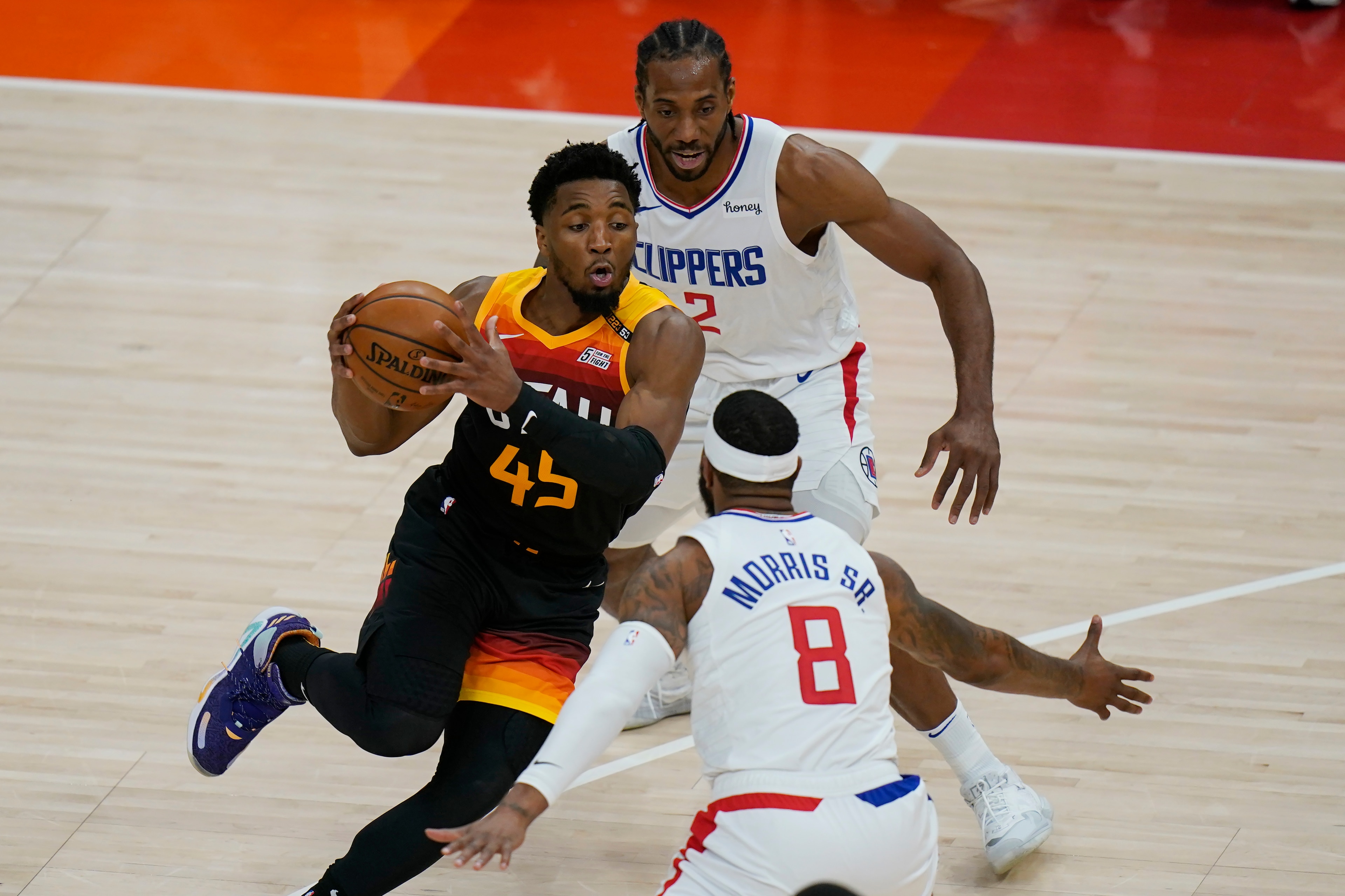 Los Angeles Clippers' Kawhi Leonard (2) and Marcus Morris Sr. (8) defend against Utah Jazz guard Donovan Mitchell (45) during the first half of Game 1 of a second-round NBA basketball playoff series Tuesday, June 8, 2021, in Salt Lake City. (AP Photo/Rick Bowmer) Los Angeles Clippers' Kawhi Leonard (2) and Marcus Morris Sr. (8) defend against Utah Jazz guard Donovan Mitchell (45) during the first half of Game 1 of a second-round NBA basketball playoff series Tuesday, June 8, 2021, in Salt Lake City. (AP Photo/Rick Bowmer)