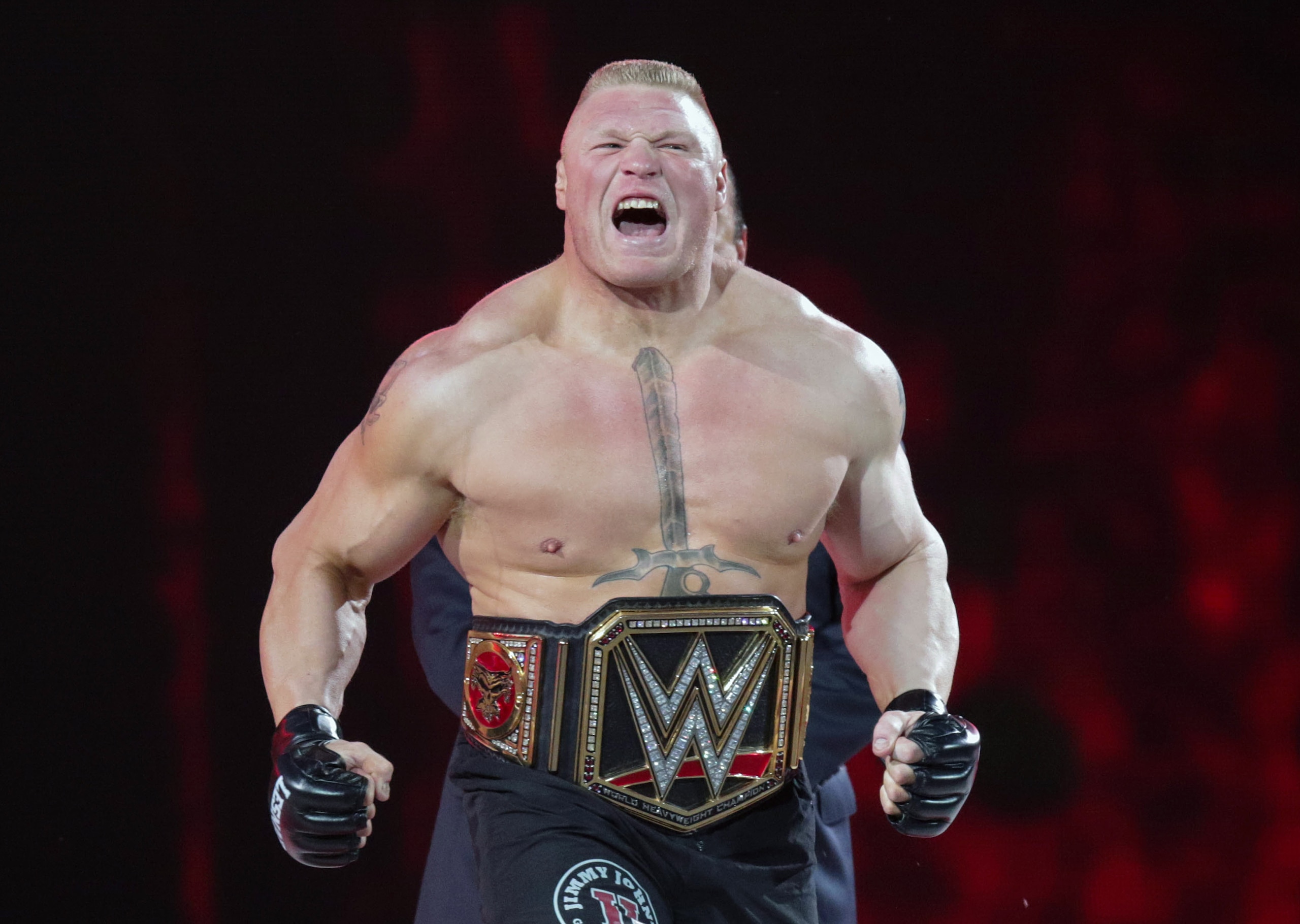 FILE - In this March 29, 2015, file photo, Brock Lesnar makes his entrance at Wrestlemania XXXI in Santa Clara, Calif. Lesnar, the former WWE and UFC heavyweight champion, was selected Monday, June 27, 2016, as the cover superstar for the WWE 2K17 video game that is set for an Oct. 11 release.  (AP Photo/Don Feria, File)