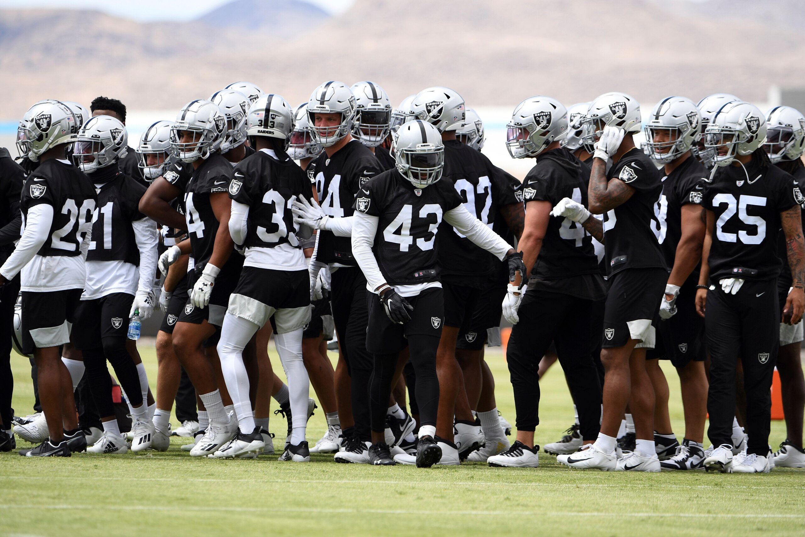 The Las Vegas Raiders defensive squad huddles up during an NFL football organized team activity at the team's training facility Wednesday, May 26, 2021, in Henderson, Nev. (AP Photo/David Becker)