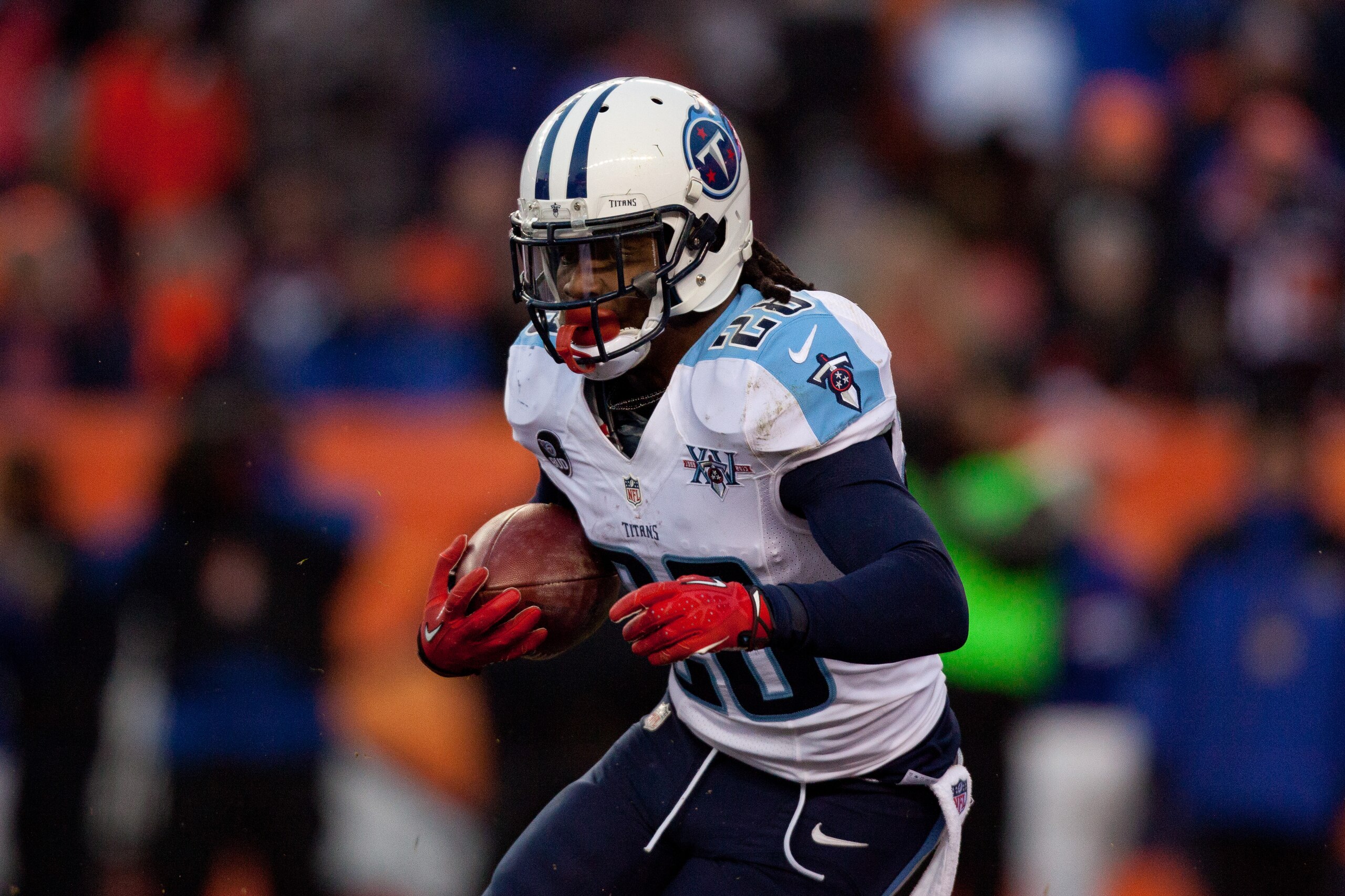 DENVER, CO - DECEMBER 8:  Running back Chris Johnson #28 of the Tennessee Titans runs with the ball against the Denver Broncos at Sports Authority Field Field at Mile High on December 8, 2013 in Denver, Colorado. The Broncos defeated the Titans 51-28.  (Photo by Justin Edmonds/Getty Images)