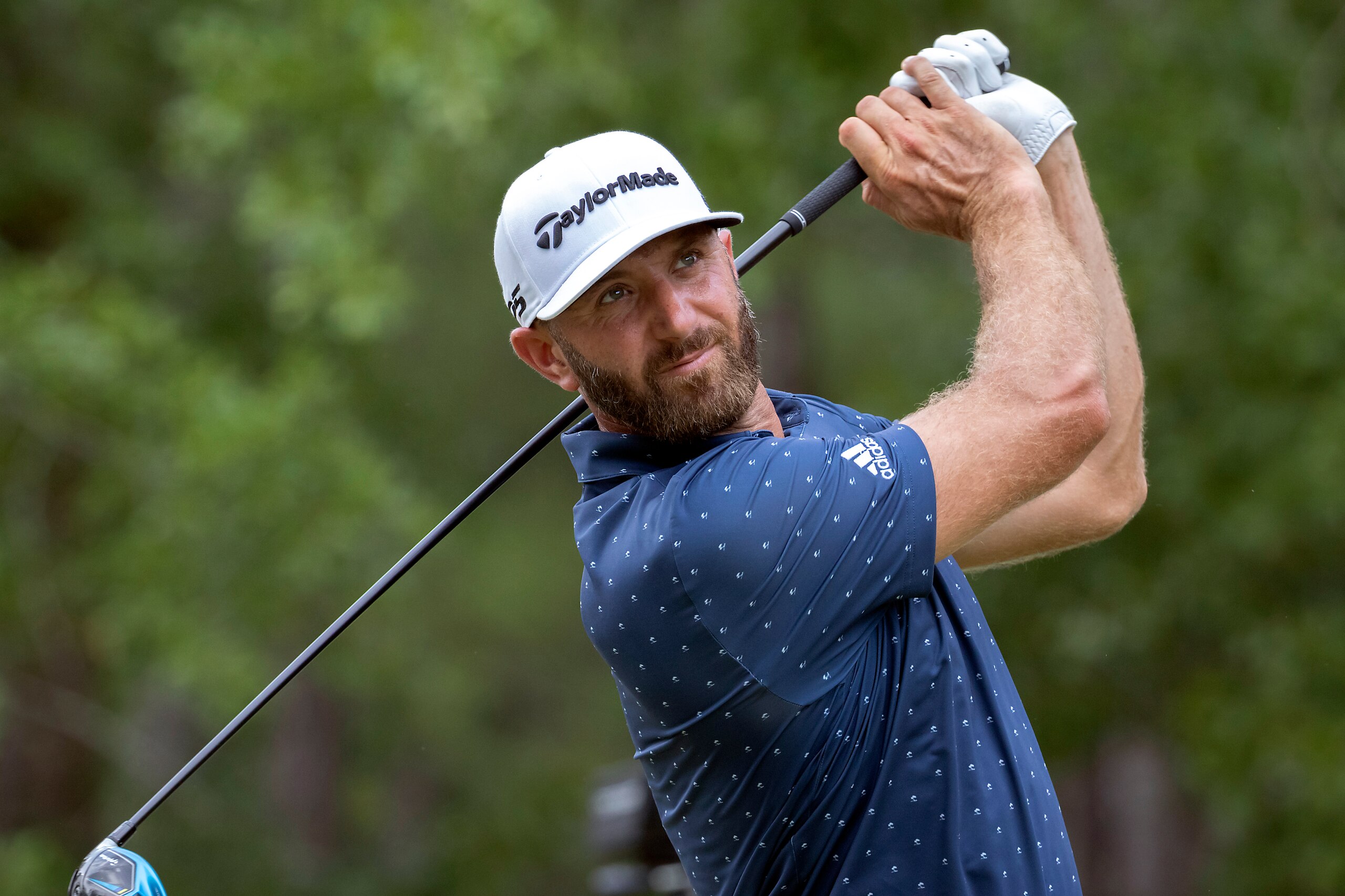 CORRECTS FARAWAY TO FAIRWAY Dustin Johnson watches his drive down the ninth fairway during the first round of the Palmetto Championship golf tournament in Ridgeland, S.C., Thursday, June 10, 2021. (AP Photo/Stephen B. Morton)