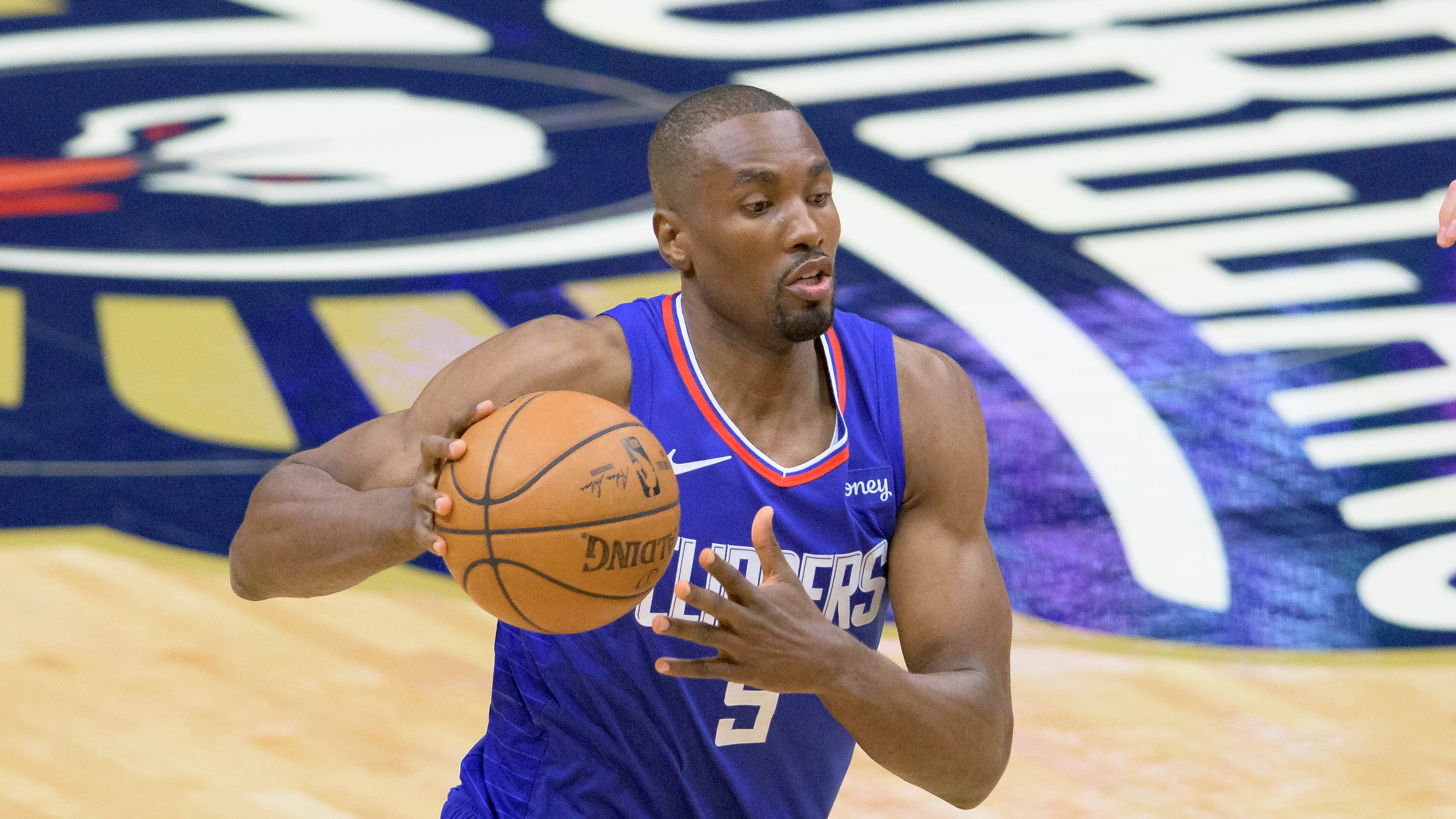 Los Angeles Clippers center Serge Ibaka (9) dribbles in the first half of an NBA basketball game against the New Orleans Pelicans in New Orleans, Sunday, March 14, 2021. (AP Photo/Matthew Hinton)