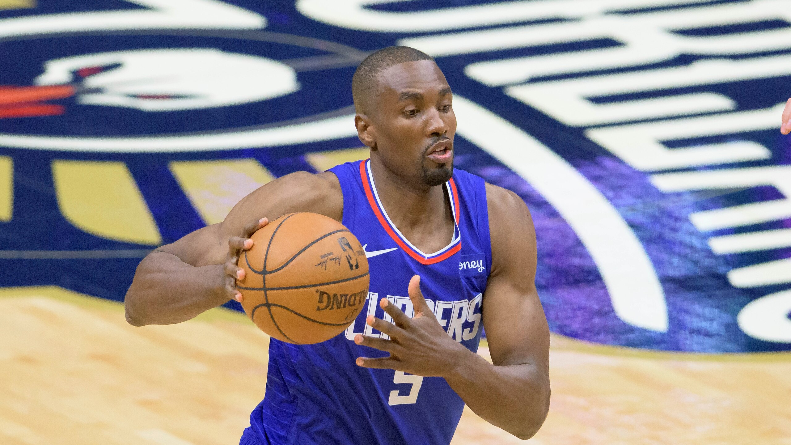 Los Angeles Clippers center Serge Ibaka (9) dribbles in the first half of an NBA basketball game against the New Orleans Pelicans in New Orleans, Sunday, March 14, 2021. (AP Photo/Matthew Hinton)