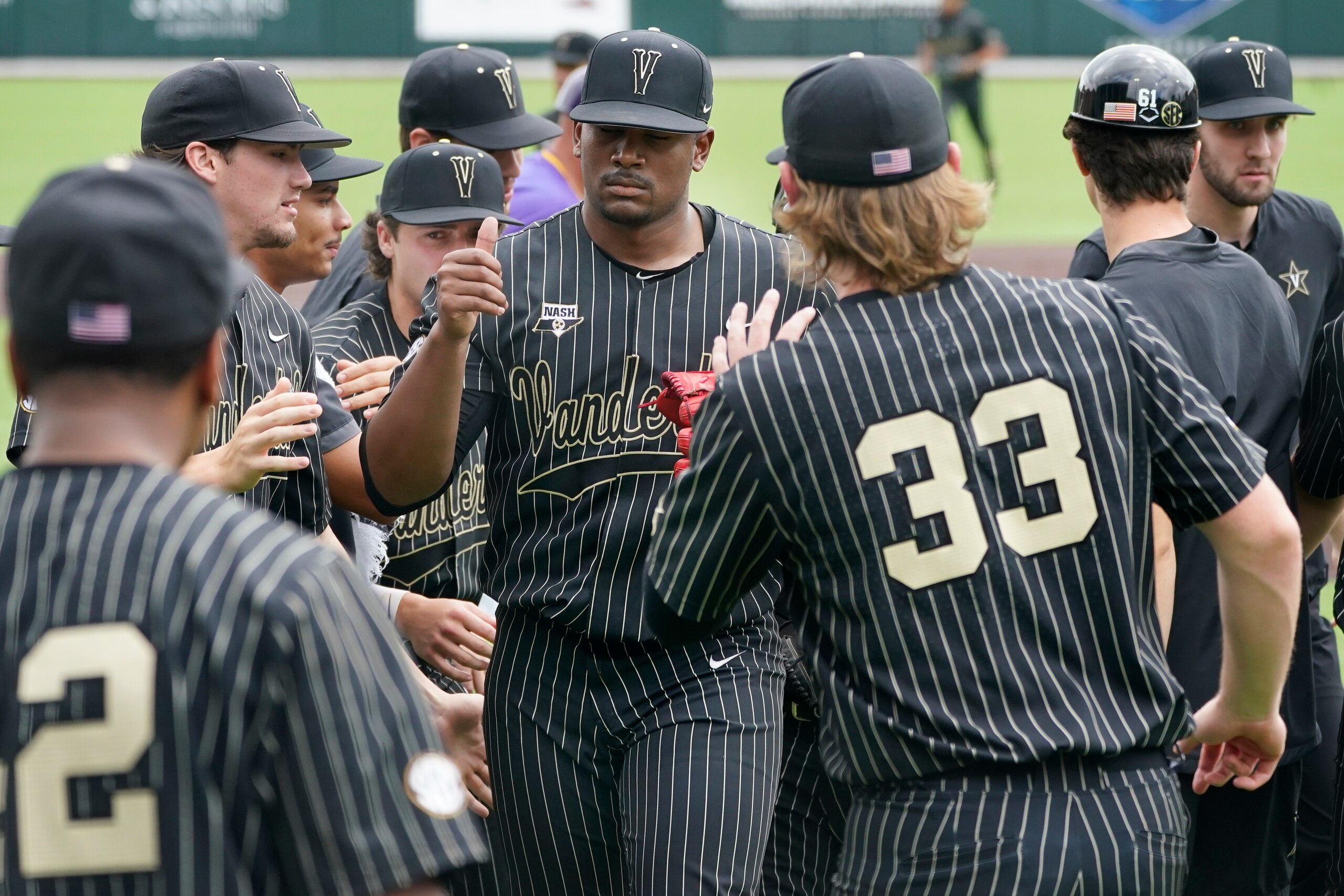 Vanderbilt pitcher Kumar Rocker, center, is congratulated as he walks to the dugout after the third out against East Carolina in the first inning of an NCAA college baseball super regional game Friday, June 11, 2021, in Nashville, Tenn. (AP Photo/Mark Humphrey)