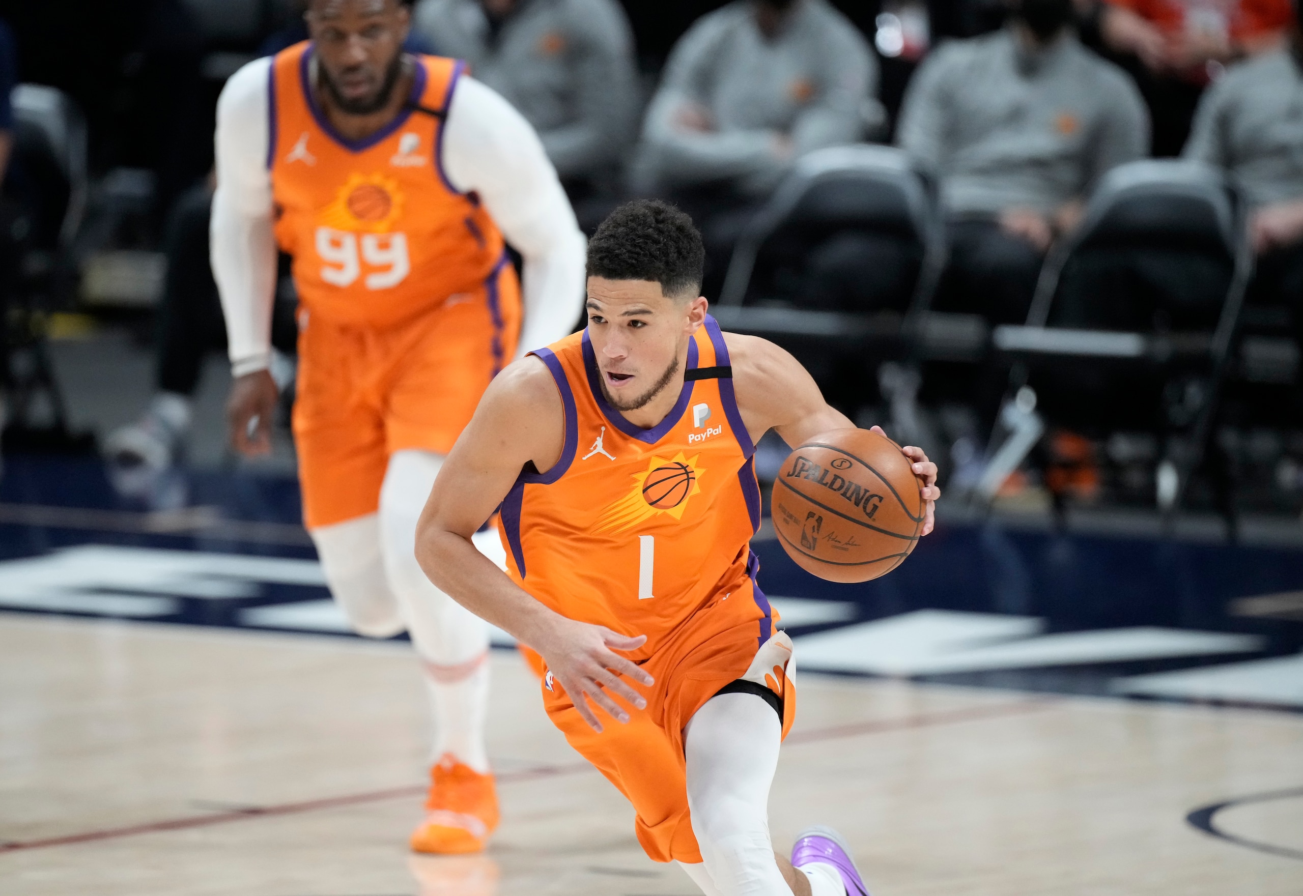 Phoenix Suns guard Devin Booker picks up the ball in the first half of Game 3 of an NBA second-round playoff series against the Denver Nuggets, Friday, June 11, 2021, in Denver. (AP Photo/David Zalubowski)