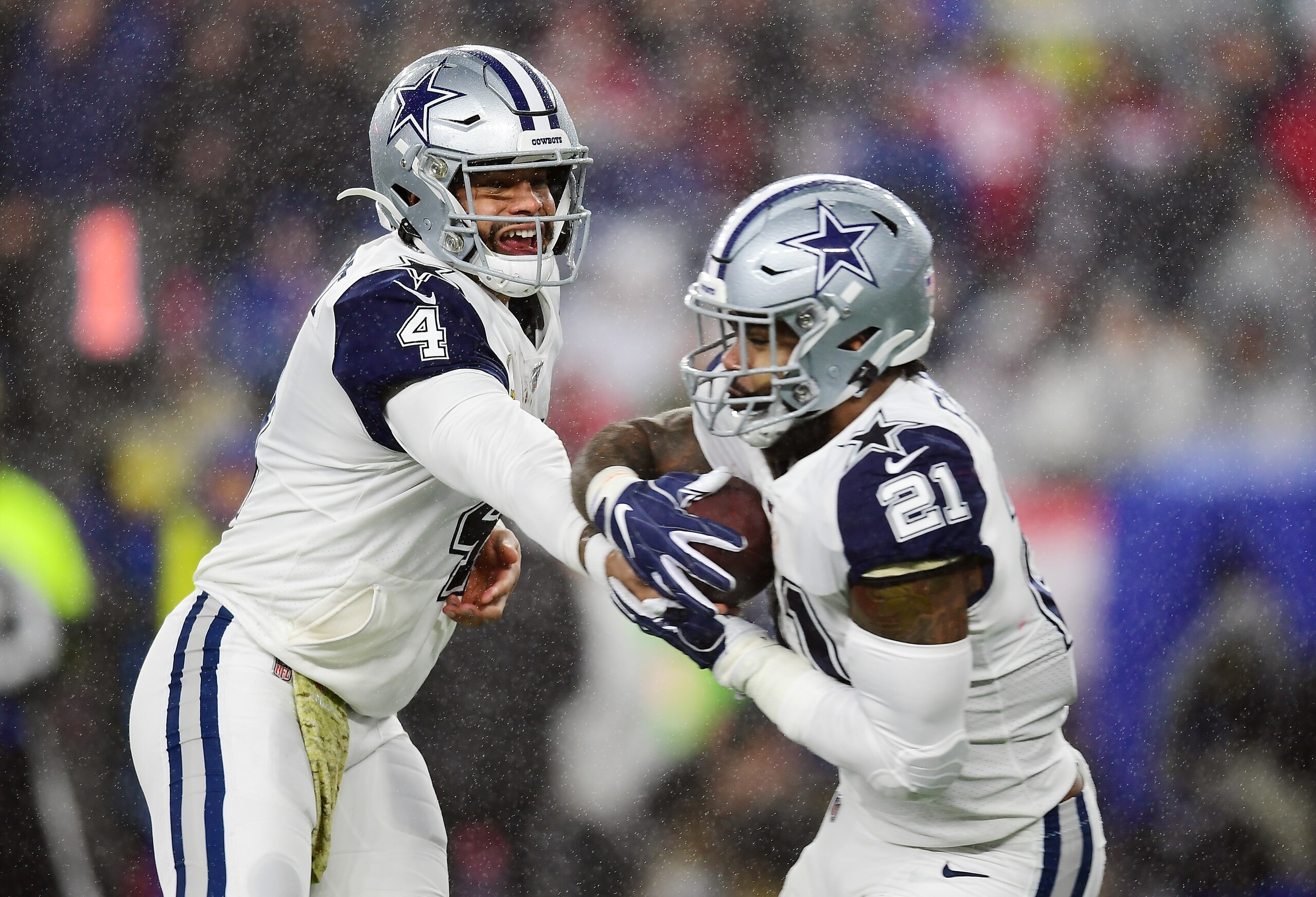 FOXBOROUGH, MASSACHUSETTS - NOVEMBER 24: Dak Prescott #4 of the Dallas Cowboys hands off to Ezekiel Elliott #21 during the first half against the New England Patriots in the game at Gillette Stadium on November 24, 2019 in Foxborough, Massachusetts. (Photo by Billie Weiss/Getty Images)